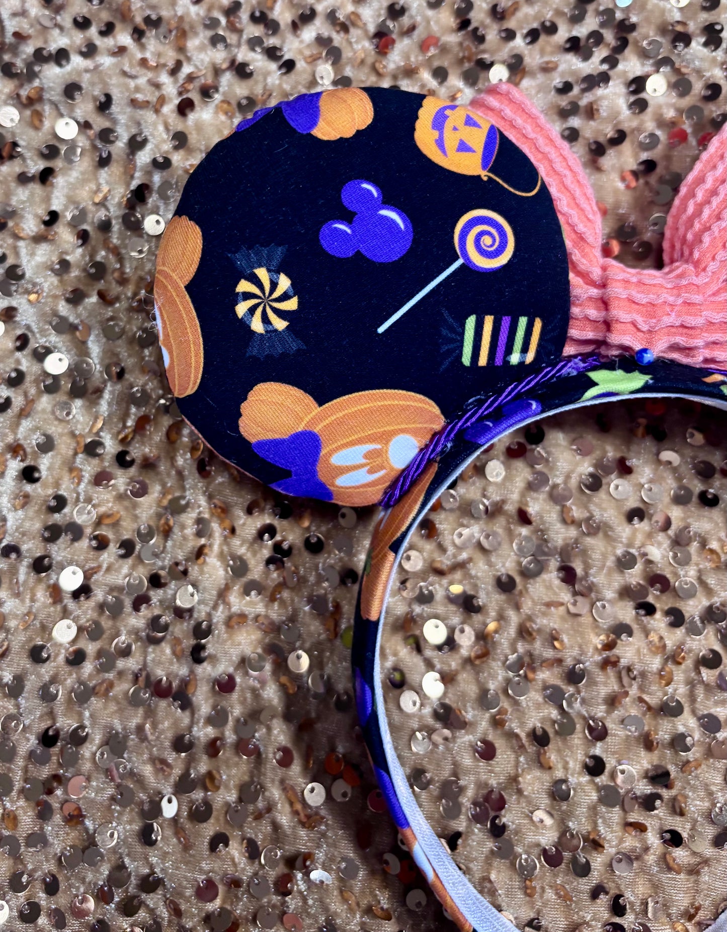 handmade mouse ears with halloween boo to you fabric on ears and the headband.  Orange waffle print bow