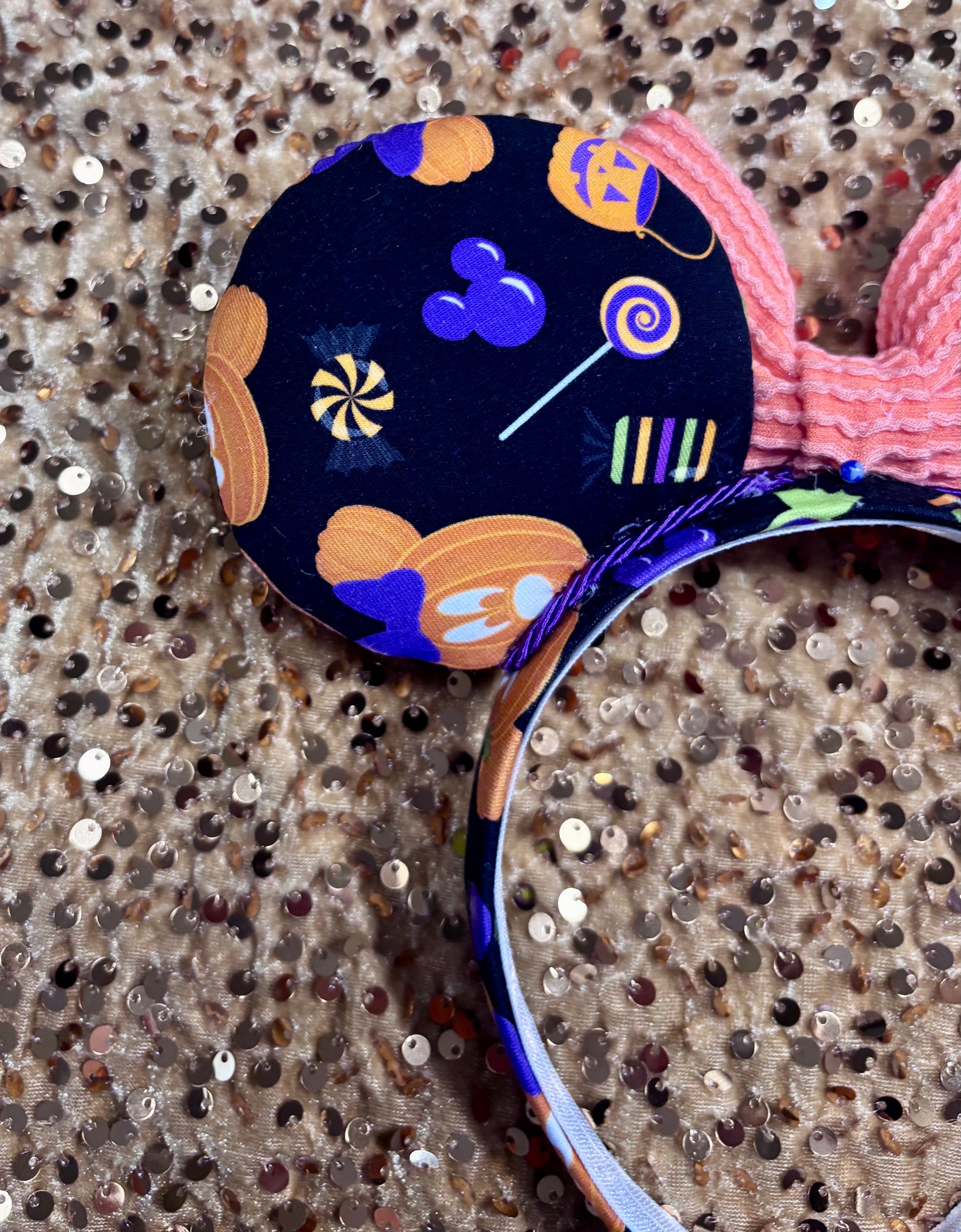handmade mouse ears with halloween boo to you fabric on ears and the headband.  Orange waffle print bow