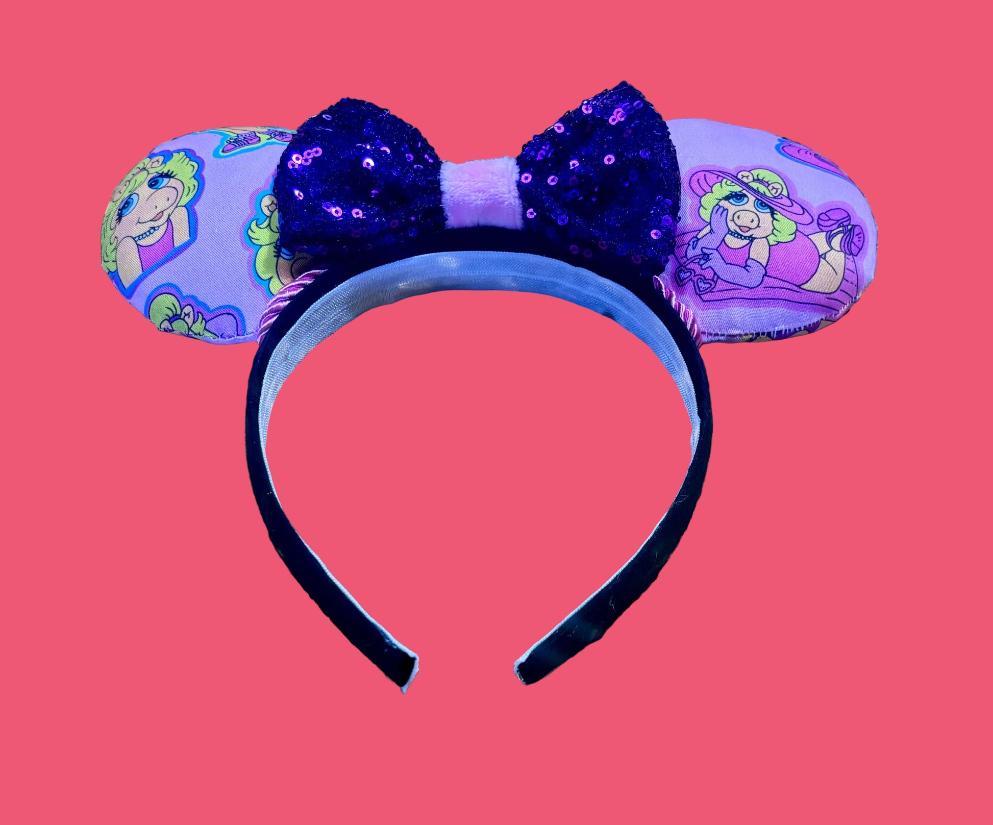 Handmade and ready to ship Piggy mouse ears. Miss Piggy fabric is on the front and the back. On a universal sized black poly fabric headband. With a purple sequin with pink soft middle on the bow. 