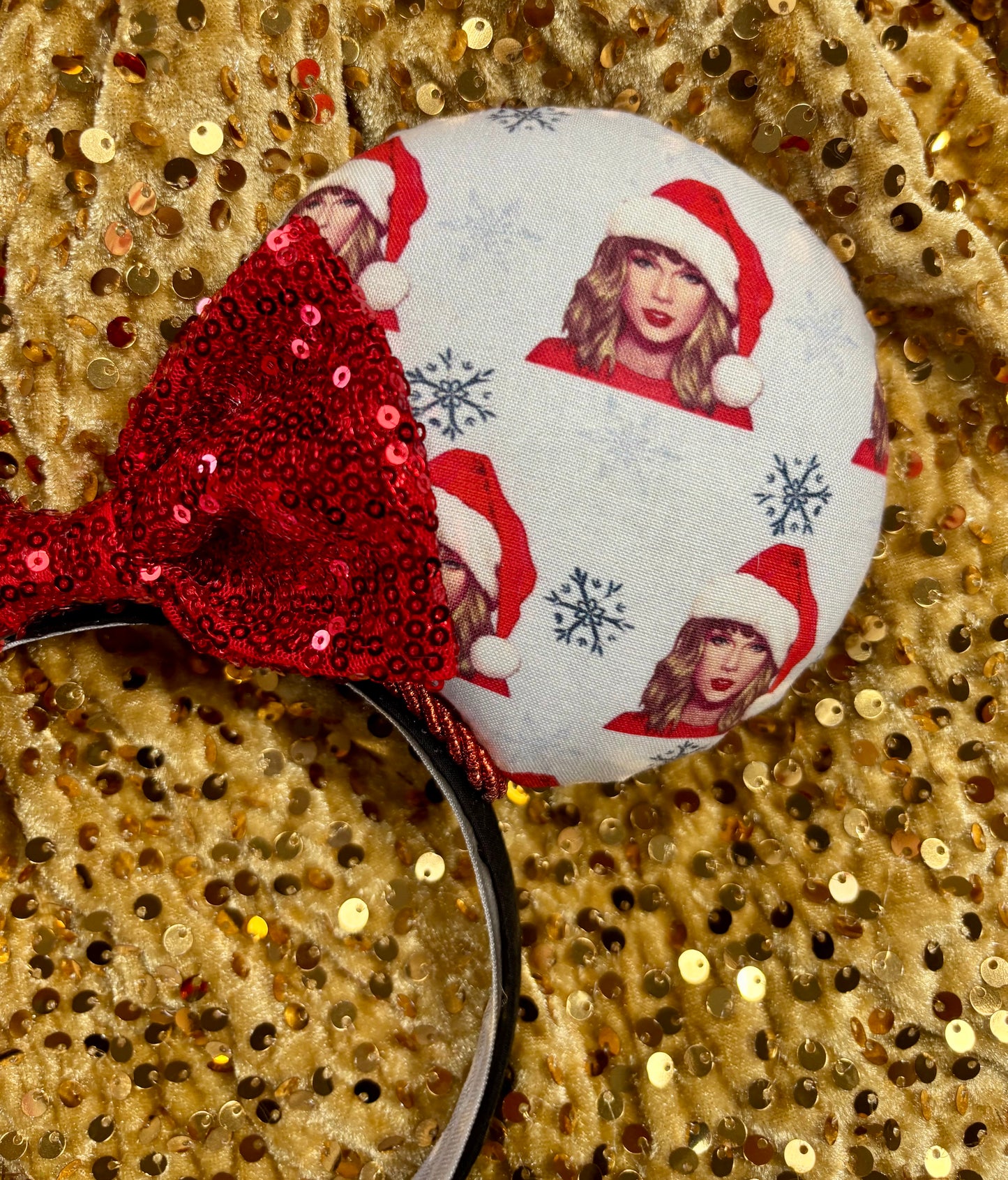 Mouse ear headband with red bow and character print on a glittery background