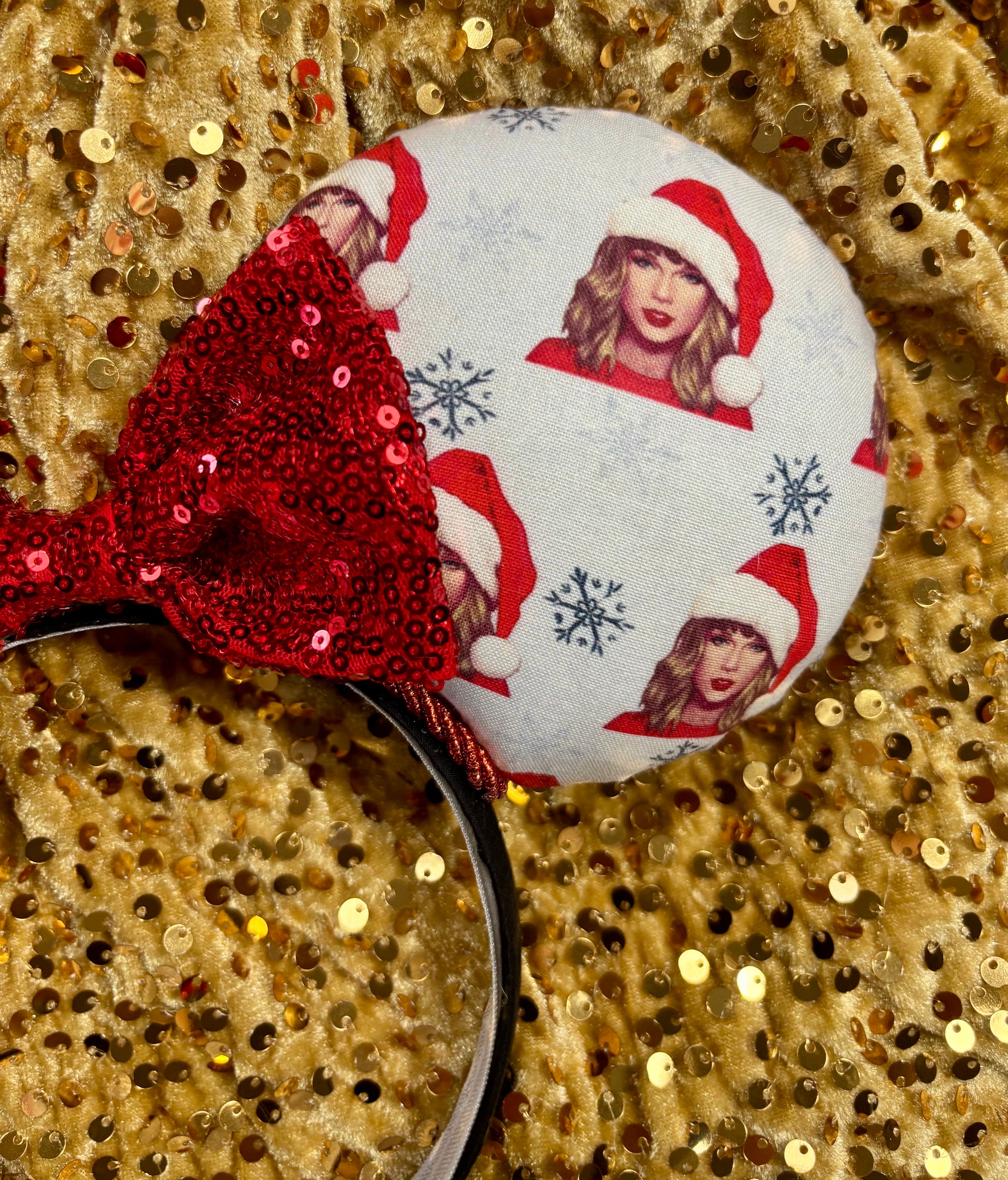 Mouse ear headband with red bow and character print on a glittery background