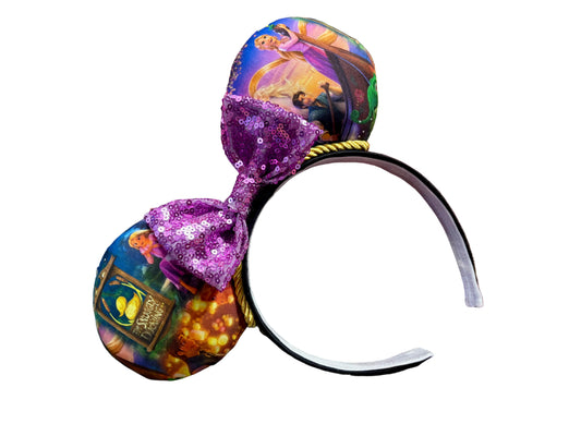 Decorative headband with colorful design and glittery accents on a textured background