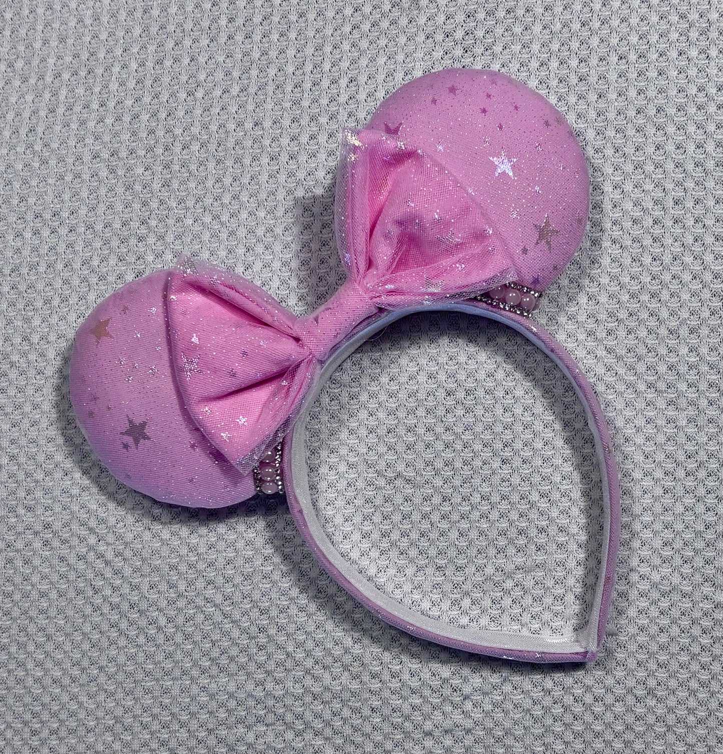 Handmade and ready to ship Pink Sparkling Iridescent fabric on pink to make mouse ears with the fabric on both the front and back along with the headband the is universal sized and fits most. The set has a matching bow, but you can request any sequin color in your order and I'll attach it. Item is shown on a white background.