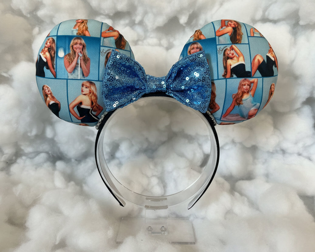 Sabrina Inspired Mouse ear headband with a sequin blue bow. Shown on a white cloud background