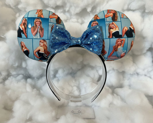 Sabrina Inspired Mouse ear headband with a sequin blue bow. Shown on a white cloud background