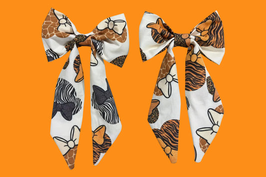 Two handmade and ready to ship fabric bows with animal print patterns in French Tailed Bows with barrette backings. 