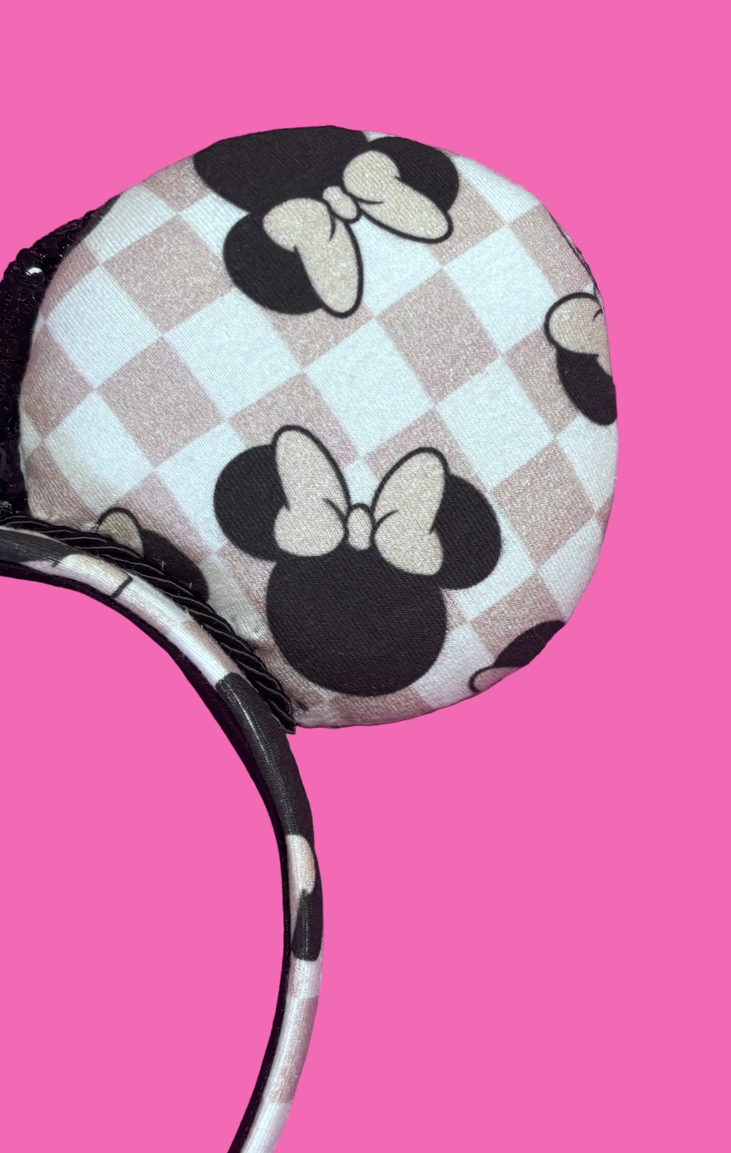 back side view of right ear. Handmade and ready to ship Checkered Mouse ears with famous Minnie ear bows on the design and a black sequin bow with black twisted trim on a universal sized headband.