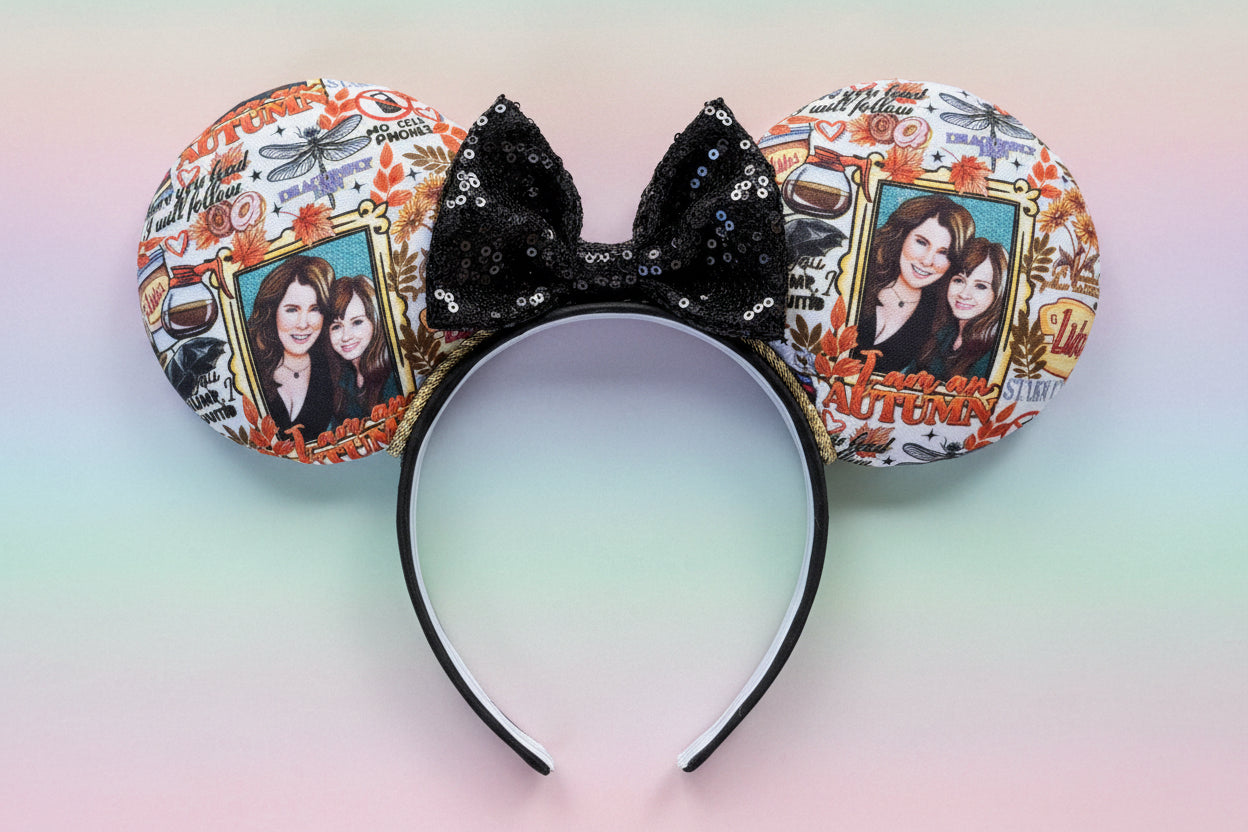 Mouse ears with decorative Gilmore girls inspired comic design and black sequin bow on a black headband. Shown on a gradient background