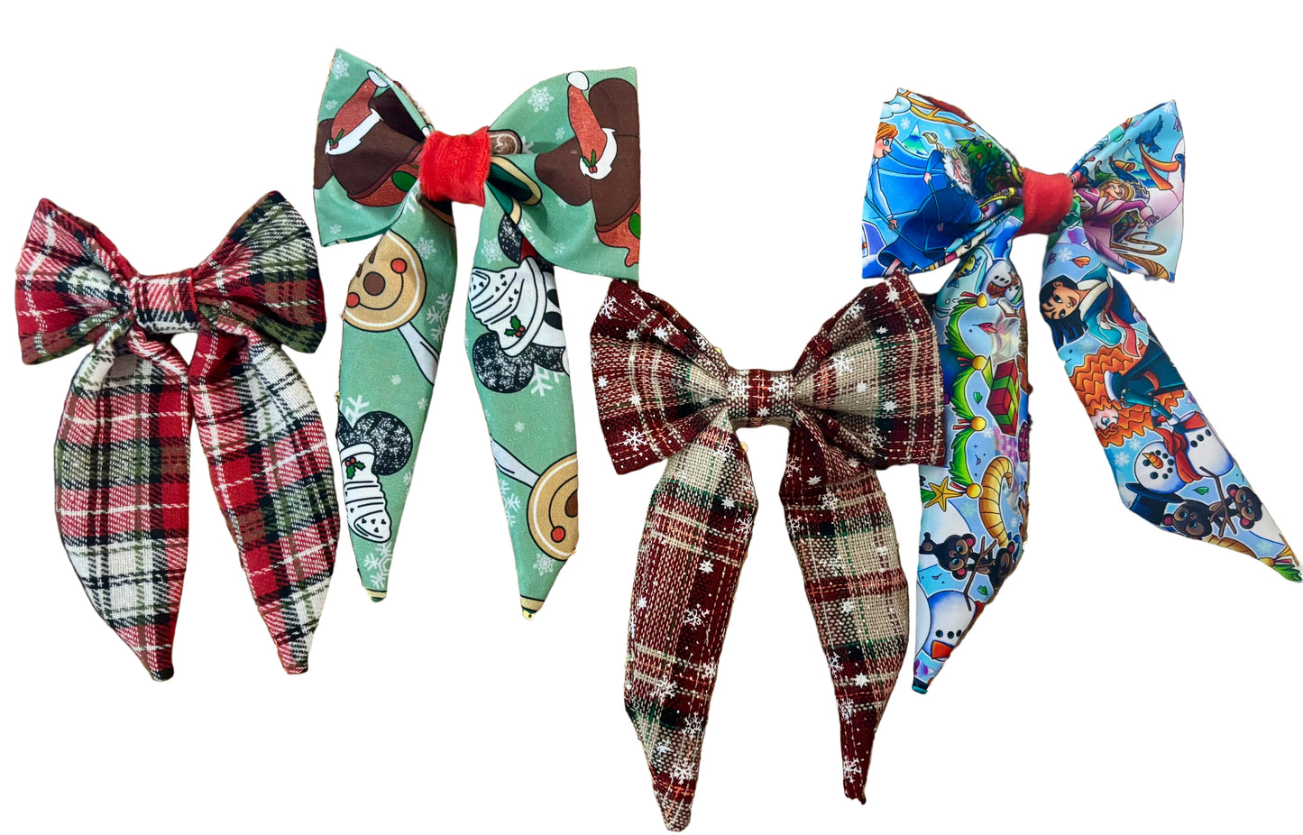 Four colorful French tailed hairbows/ one in red plaid, one in Christmas treats, one in plaid and snowflakes and one in Christmas princesses. Made and ready to ship and handmade.
