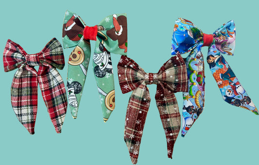 Four colorful French tailed hairbows, one in red plaid, one in Christmas treats, one in plaid and snowflakes and one in Christmas princesses. Made and ready to ship and handmade.