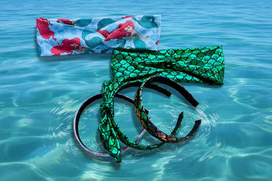 Mermaid-themed headbands on a clear blue water background