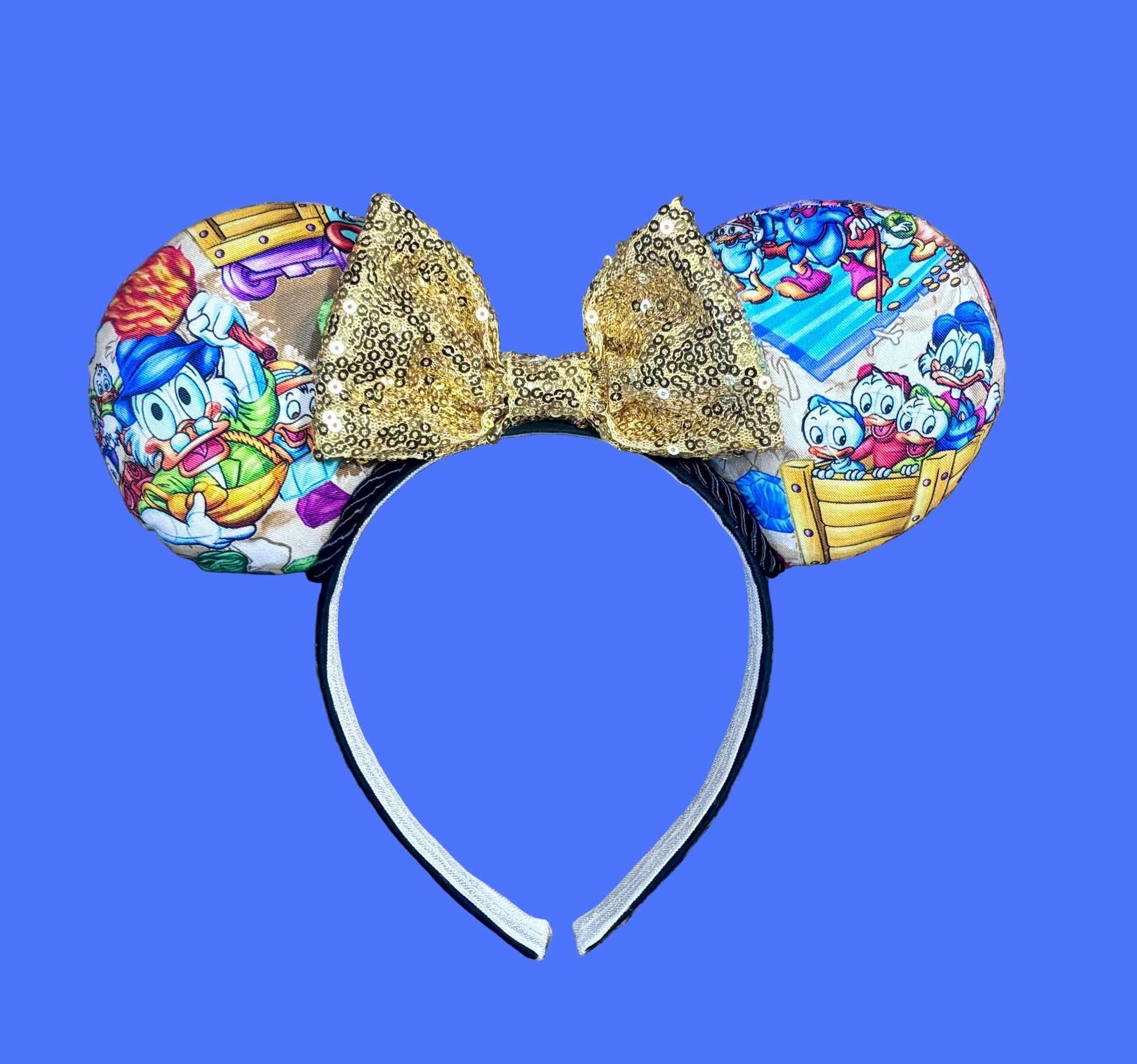 Handmade and ready to ship Colorful mouse ears with DuckTales Inspired fabric on the ears front and back with a Gold Sequin bow on a universal sized black poly cotton fabric headband.