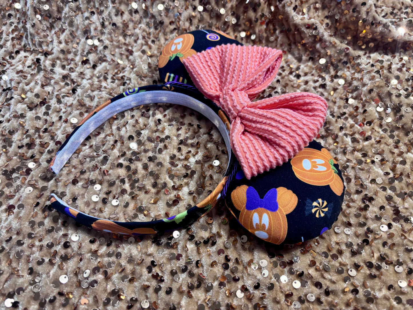 handmade mouse ears with halloween boo to you fabric on ears and the headband.  Orange waffle print bow