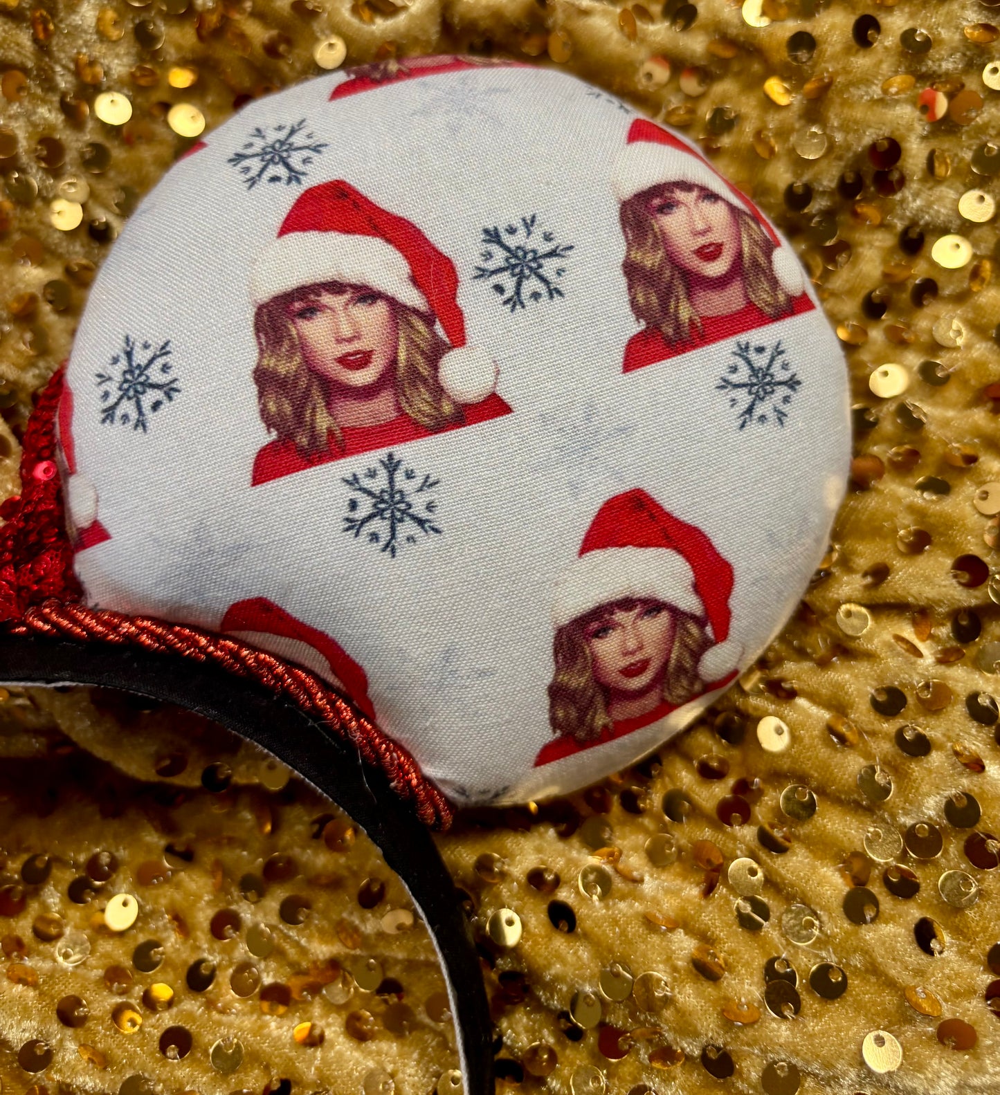 Mouse ear headband with red bow and character print on a glittery background