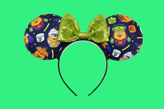 Handmade and ready to ship. The are some nostalgic chicken nuggets from the 90's in their Halloween costumes.  The Halloween pals are on these are well. Attached to a black headband with a lime green sequin bow. Shown on a white background.