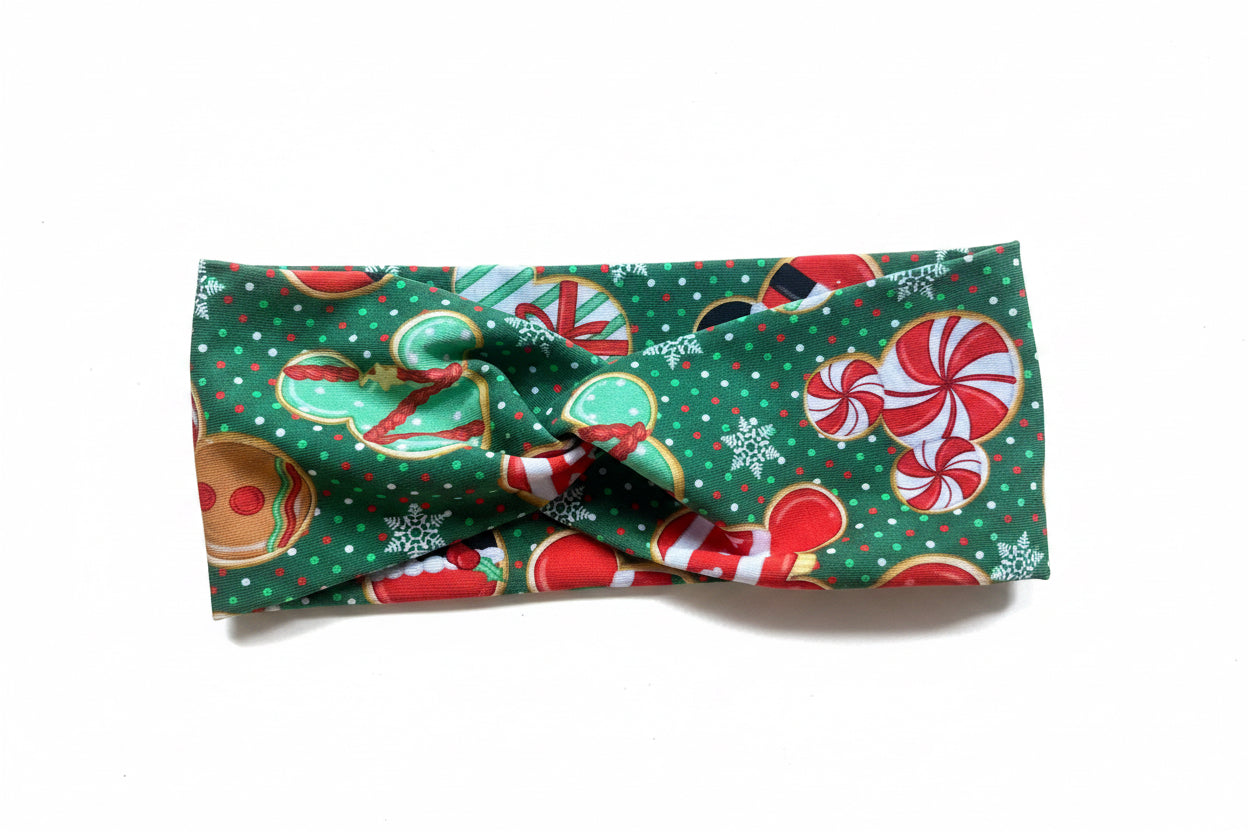 Christmas-themed headband with candy cane and gingerbread design on a white background