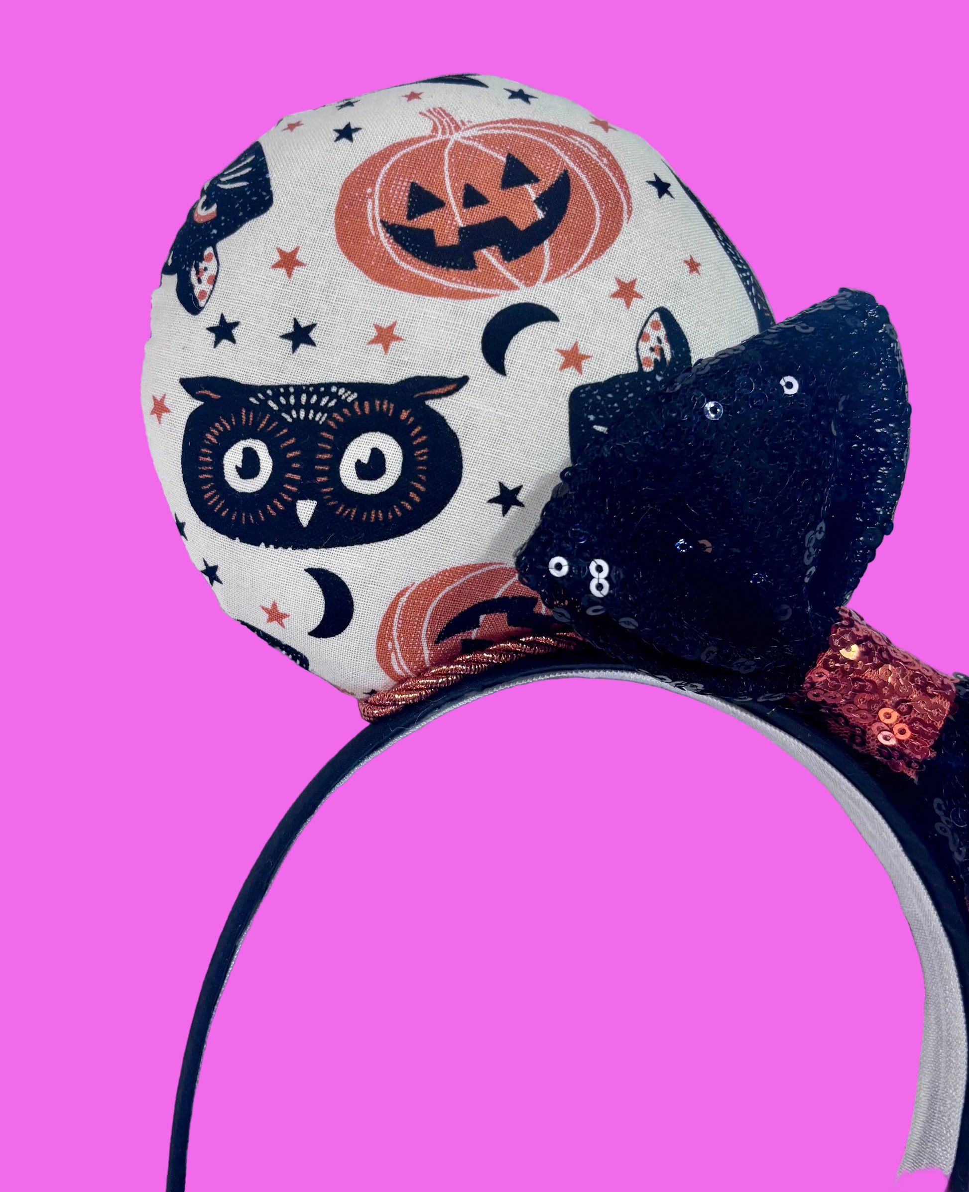 Close up of front mouse ear. Handmade and ready to ship. Halloween Mouse ears with vintage cats, owls, and pumpkin mouse ears are on the front and back of mouse ears with a black sequin with orange middle bow.