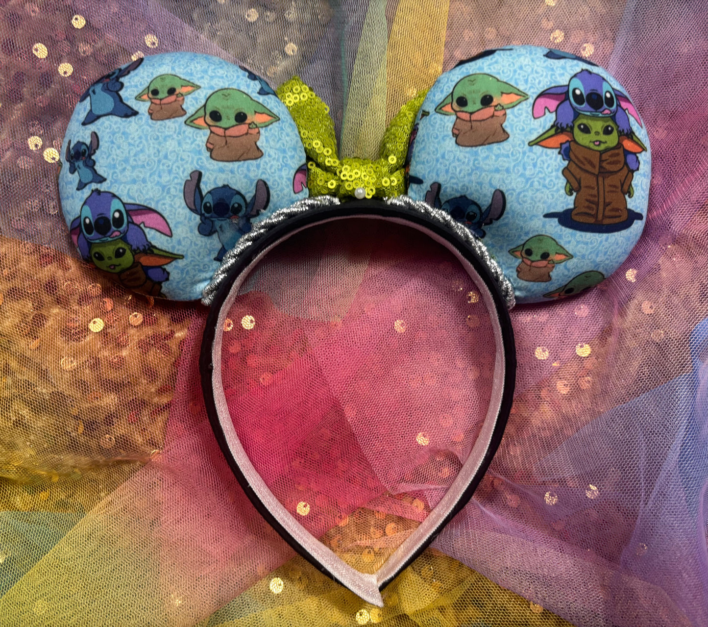 Mouse ears with cartoon character design on a glittery background