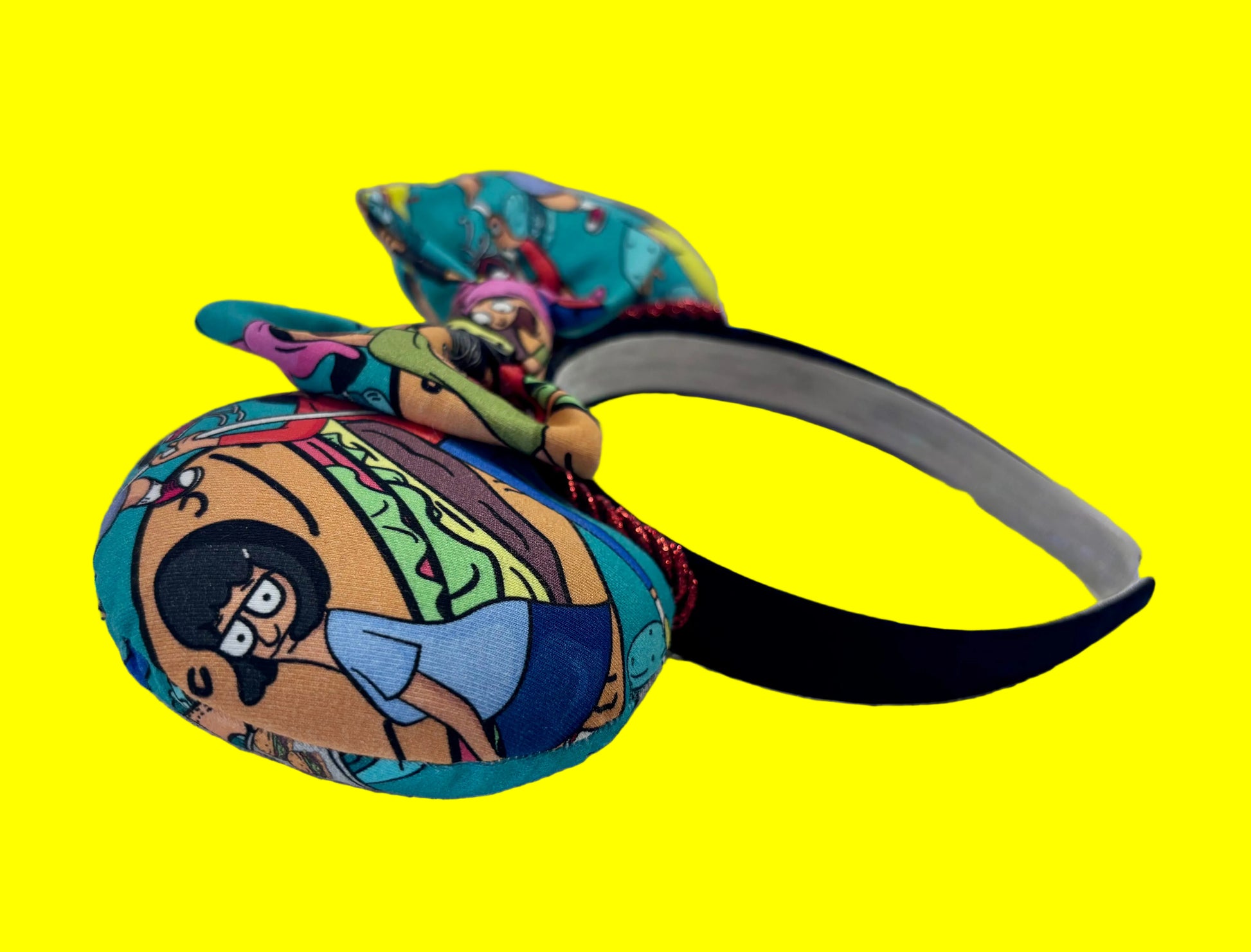 The side view of mouse ears. Handmade and ready to ship Burger Boss Mouse ears with the fabric on the ears, front and back and the bow. The headband is a universal sized headband and has black poly cotton fabric on it.