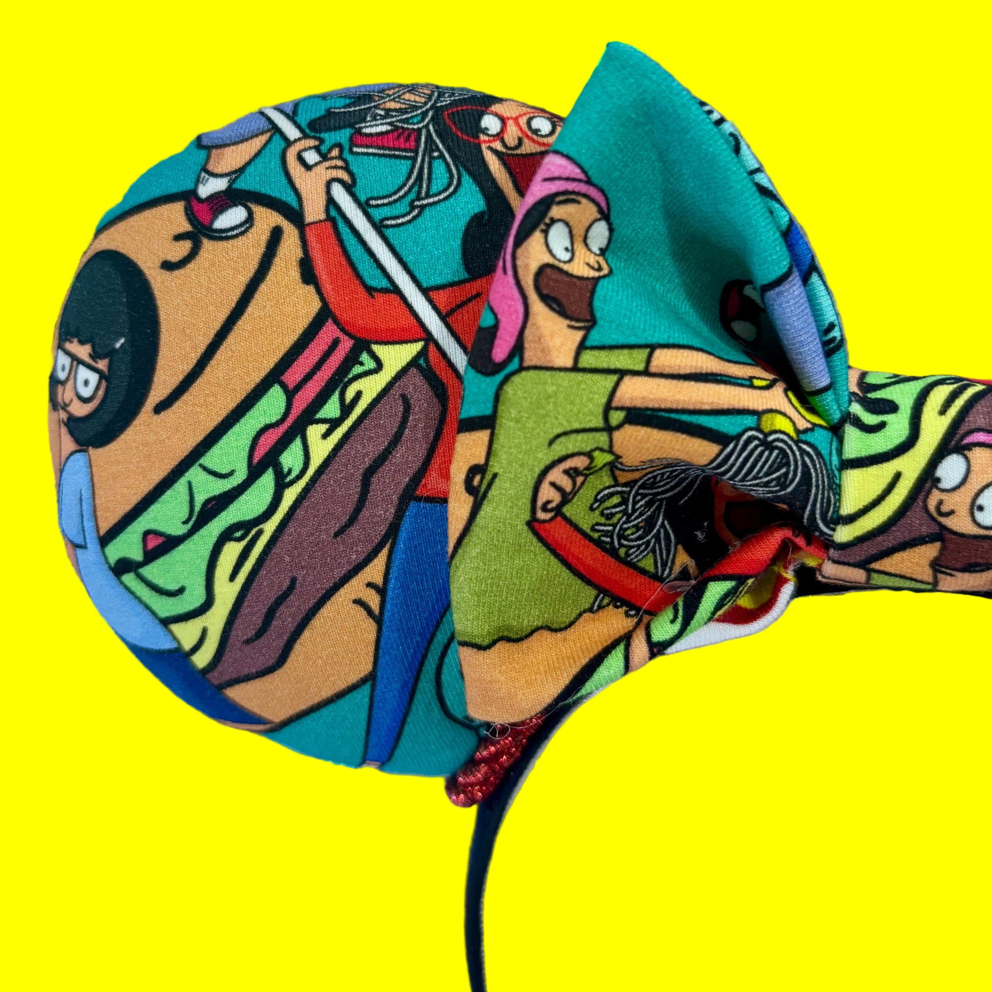 Close up of front mouse ear showing a burger a characters from the show.