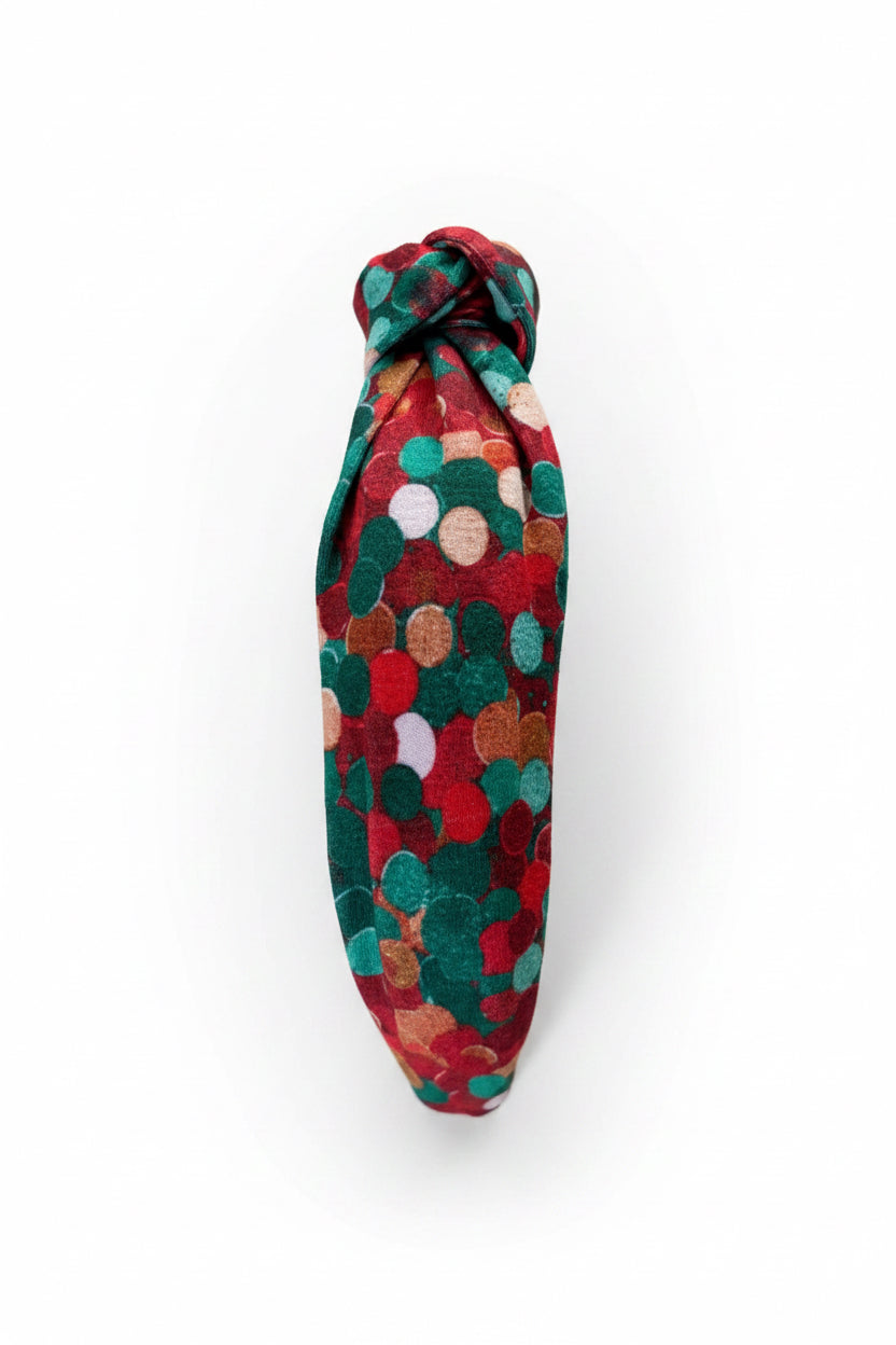 The other side view of the Christmas Dots headband on a stand.