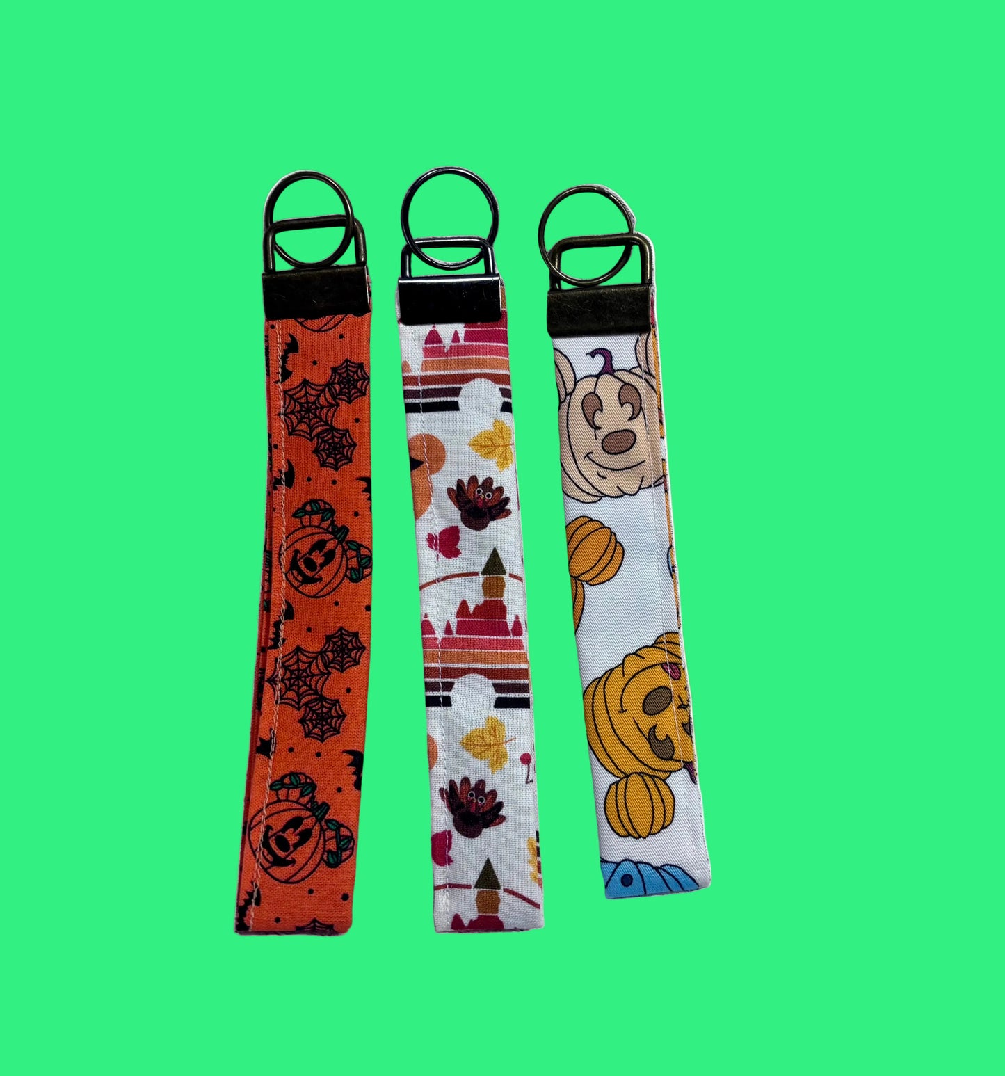 Handmade and ready to ship. Three keychain wristlets with Halloween-themed designs in: Mouse pumpkin, boo to you and thanksgiving fabric designs. 