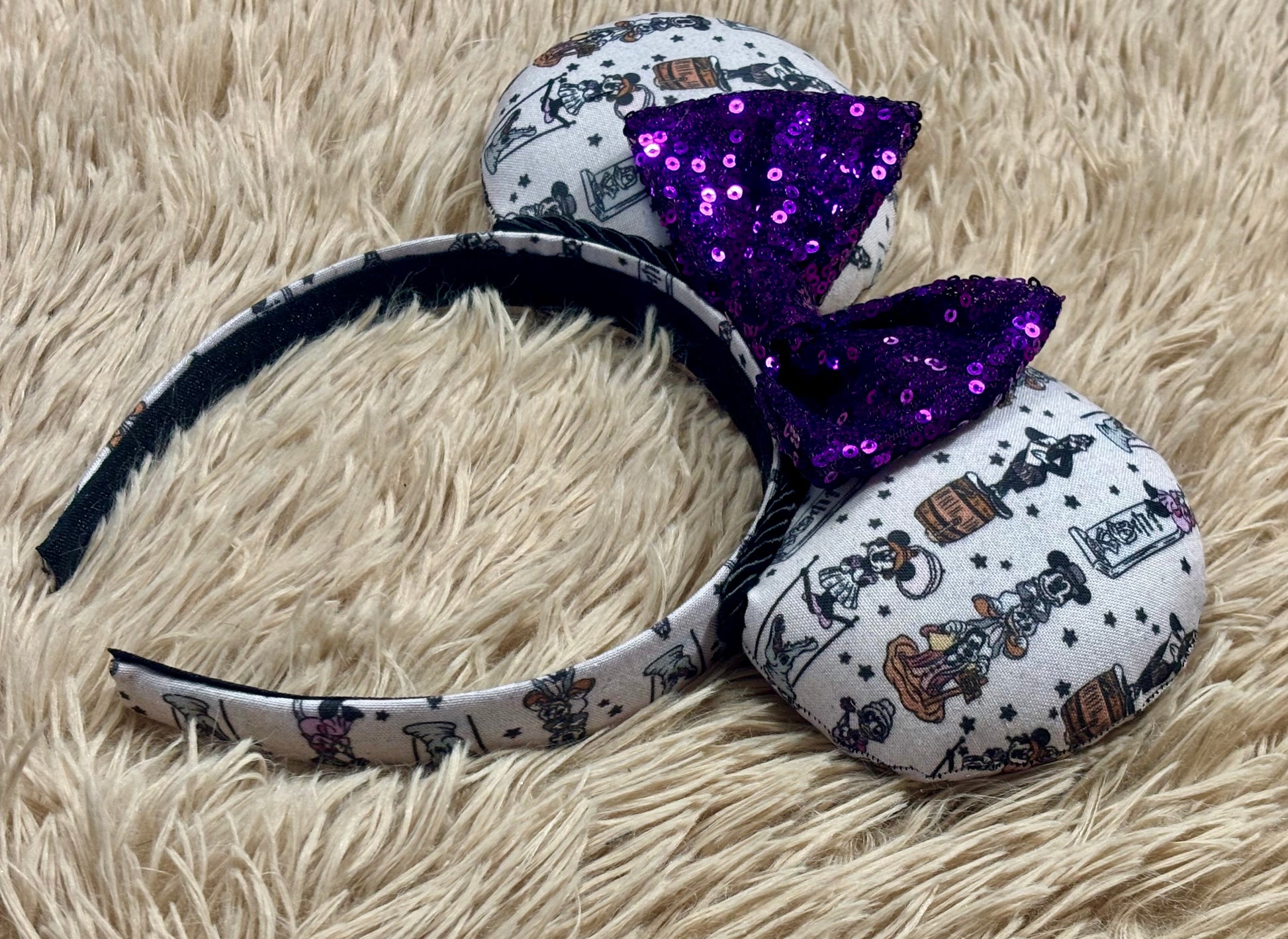 A set of ears with a fab 5 stretching room fabric on the ears front and back along with the headband as well. Black twisted trim along the inner ears with a purple sequin bow. 