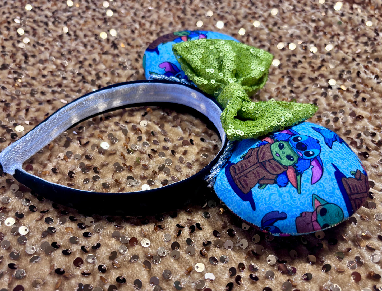 Side view of headband. Handmade and ready to ship small friend aka Stitch and Baby Yoda Mouse ears with a lime green sequin bow. Of course, you can request any bow in sequin if you prefer and I will attach it. Shown on a white background.