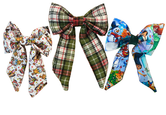 Three colorful hair bows in Christmas Pals, plaid and Snow Friends on a glittery white background