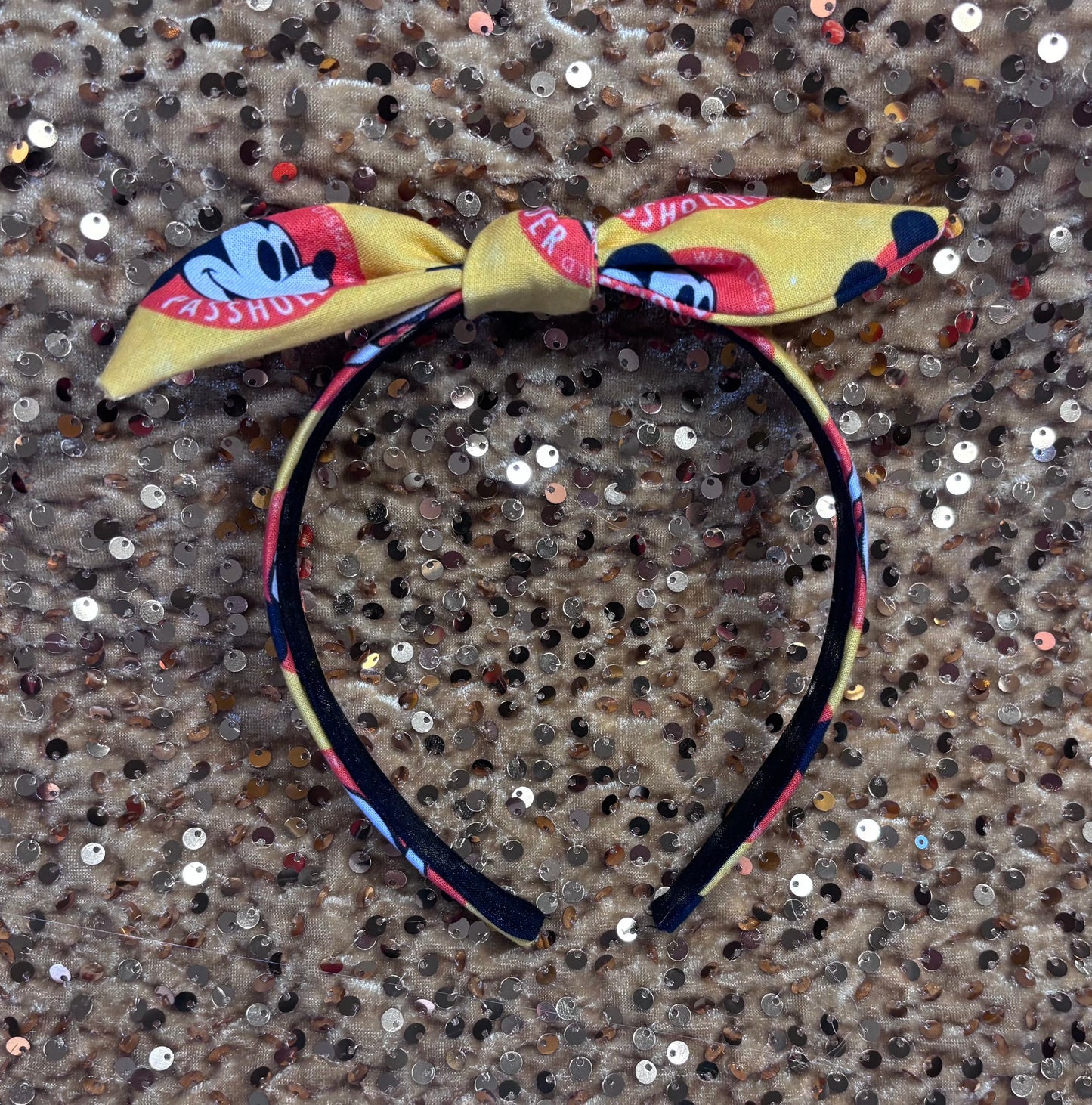 Headband with bow design on a textured surface. Made and ready to ship.