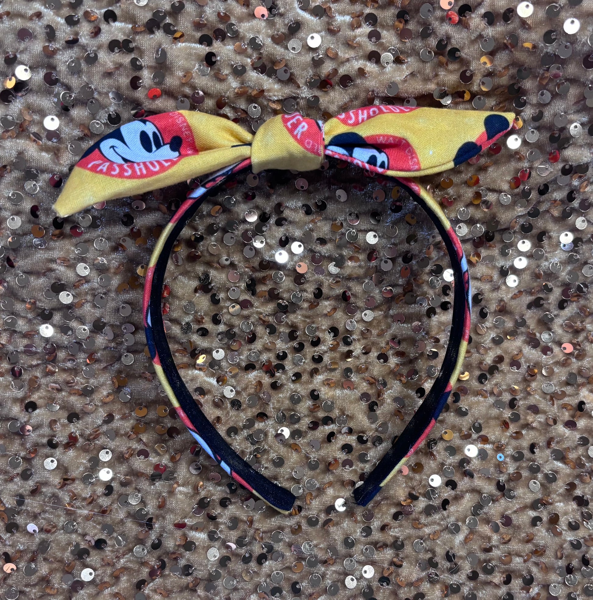 Headband with bow design on a textured surface. Made and ready to ship.