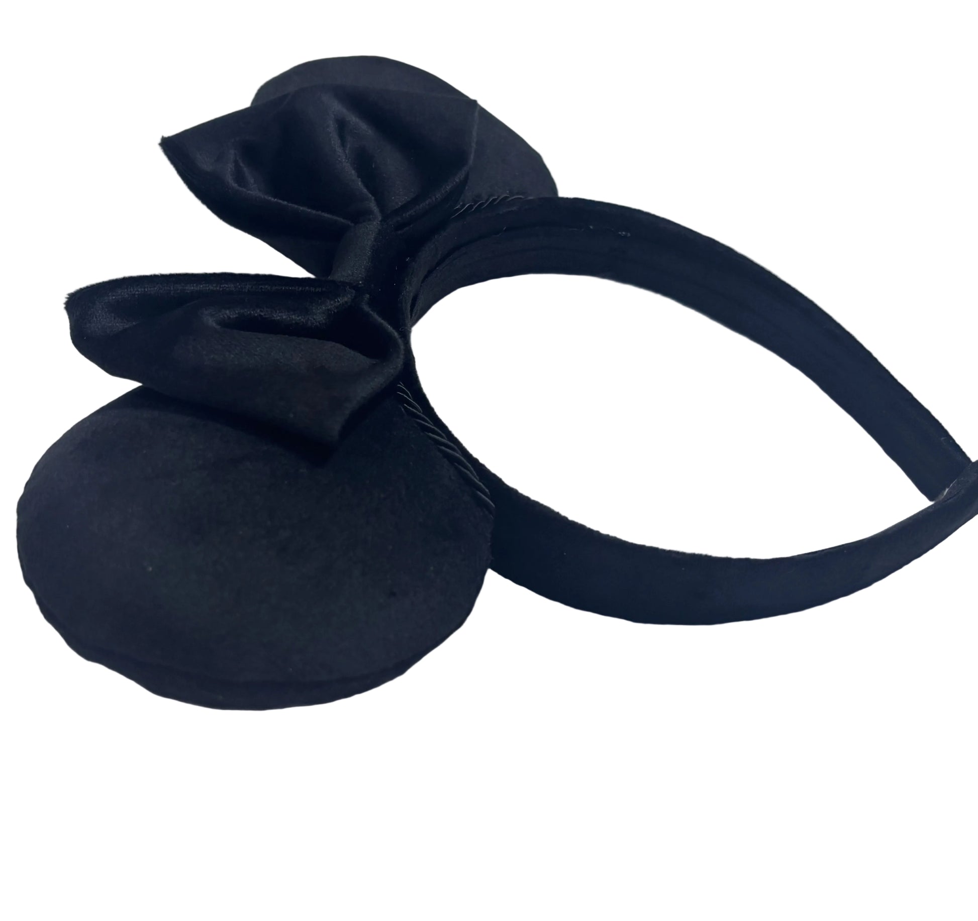 Black headband with bow on a textured white background