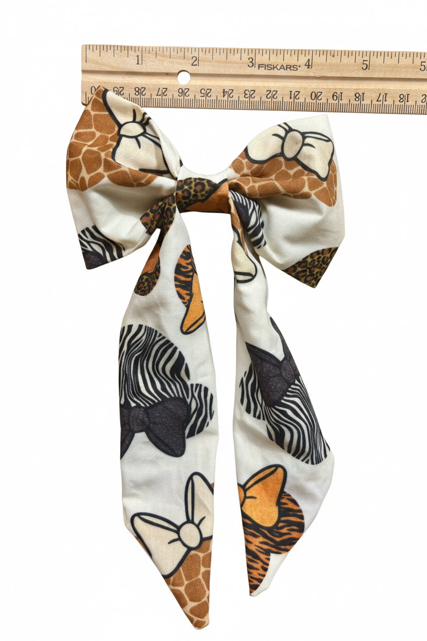 Animal print bow with a ruler for scale on a white background. Handmade and ready to ship. 