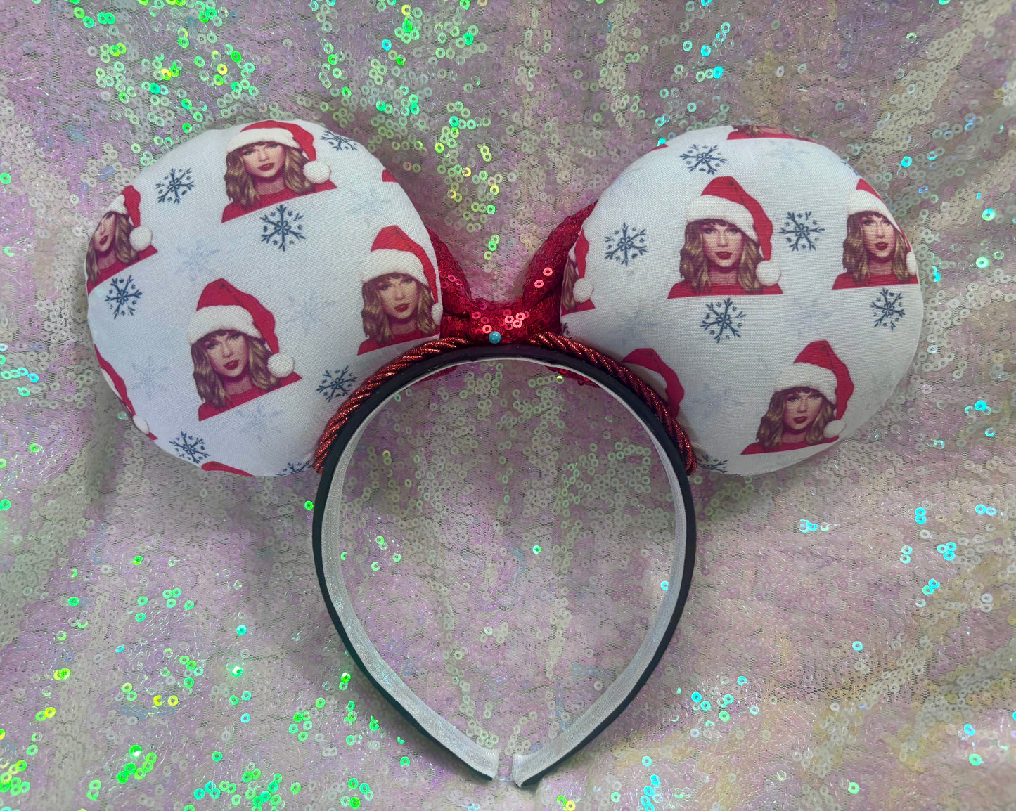 Mouse ear headband with red bow and character print on a glittery background