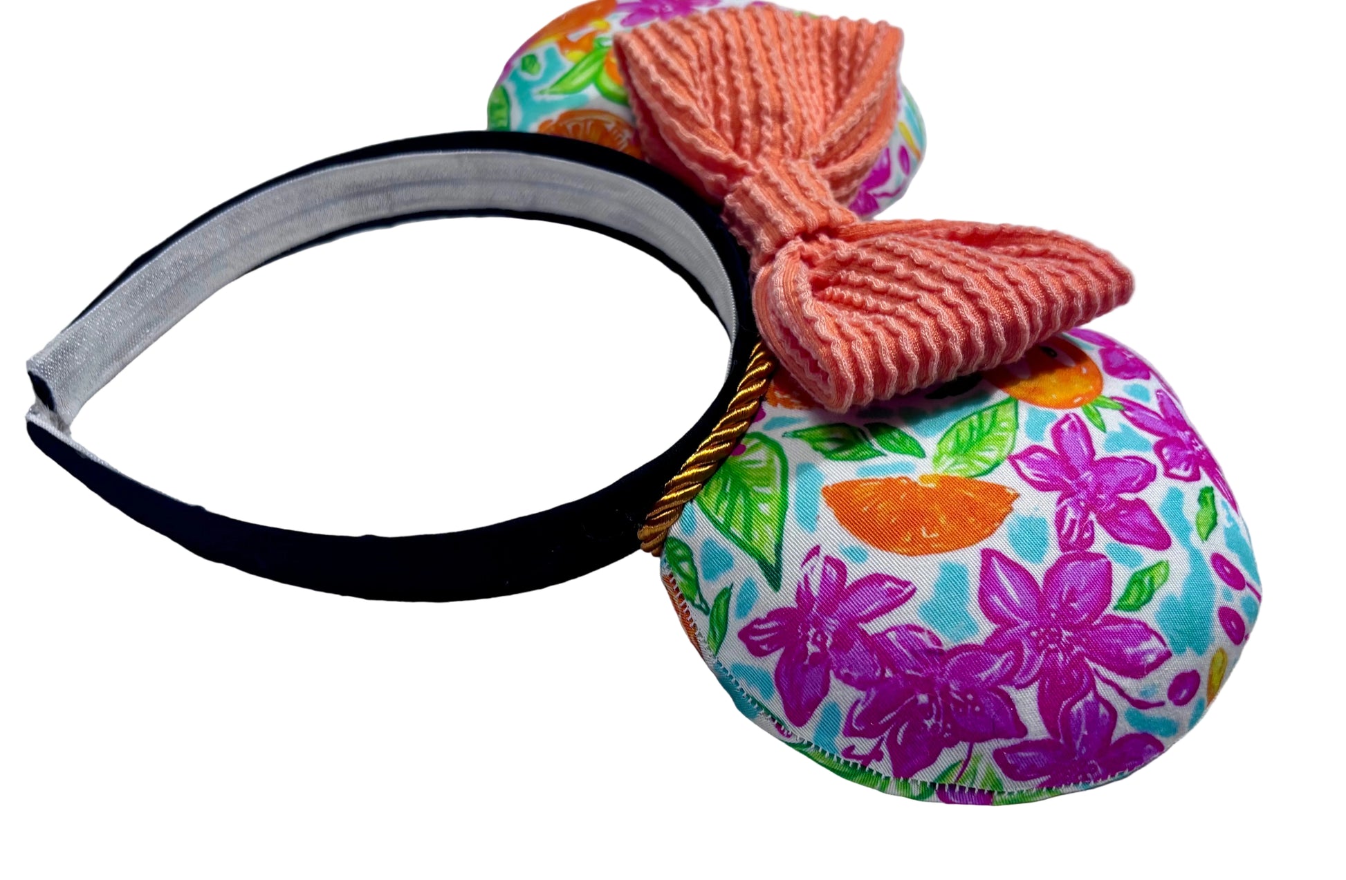 Colorful hair accessory mouse ear headband with a bow on a textured surface