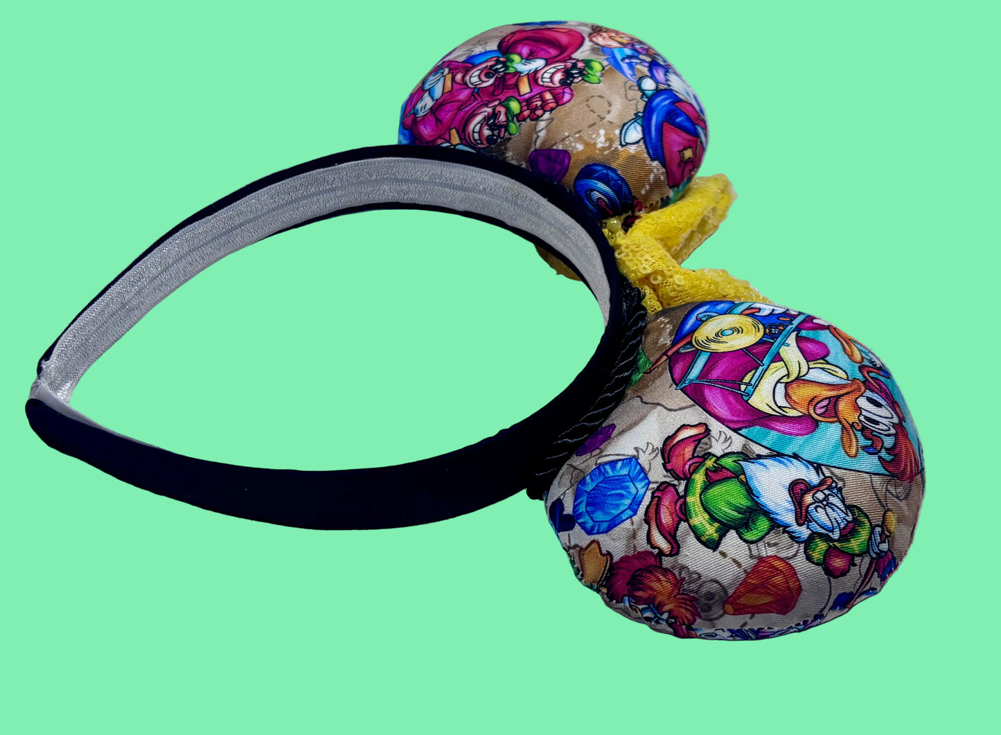 Colorful mouse ears with DuckTales Inspired fabric with a Yellow Sequin bow. Back angled view of the headband. 