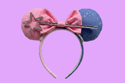 Handmade and ready to ship Sleeping Beauty Inspired Custom Ears. Sparkling Iridescent fabric is on both side of ears and the headband as well. Half blue and half is pink. The headband is universal sized and fits most. The set has a matching pink bow, silver trim and a magic want in the bow middle. 