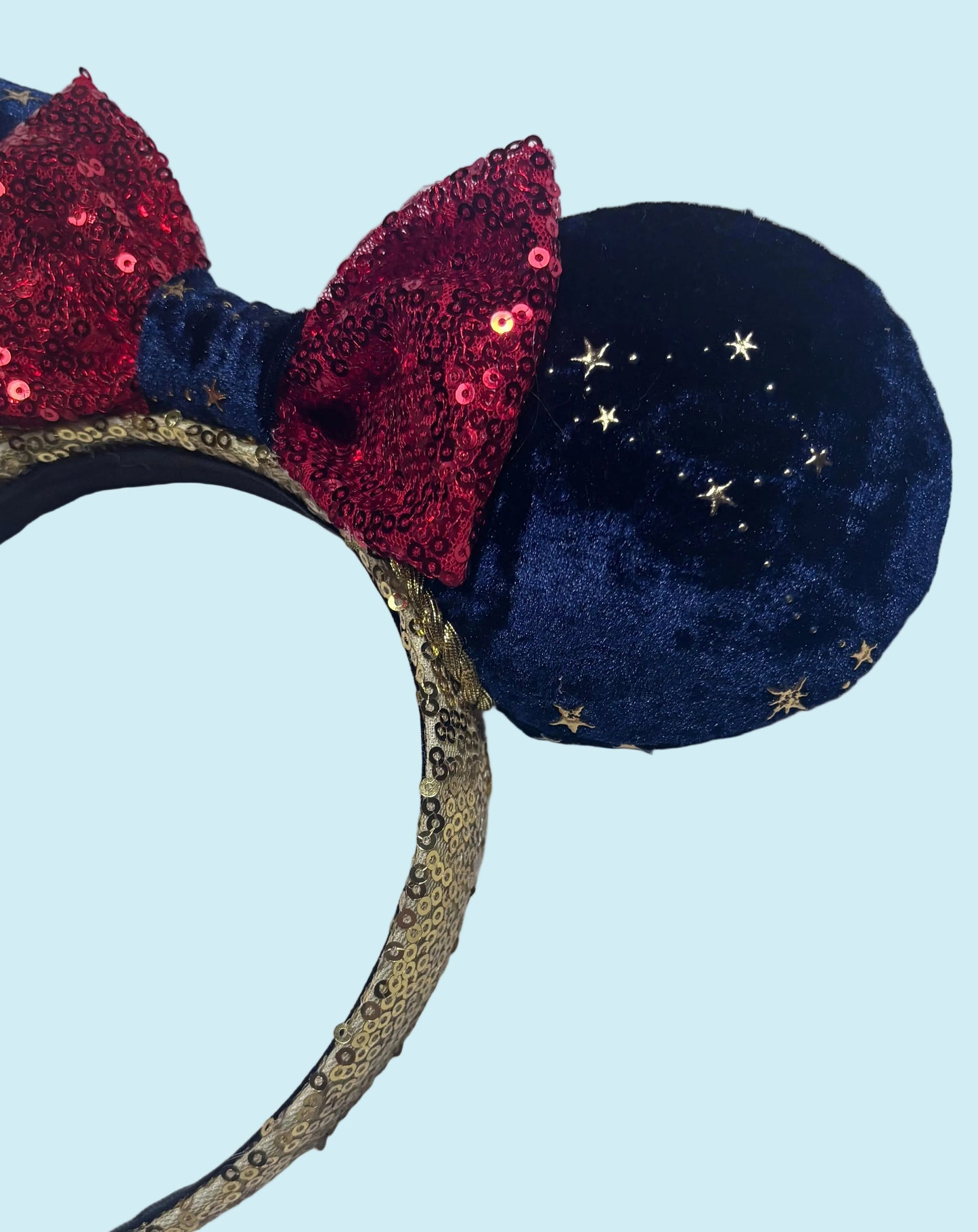 Handmade and ready to ship Navy Velvet fabric with gold stars and red sequin bow mouse ear headband on a gold sequin universal sized headband. 