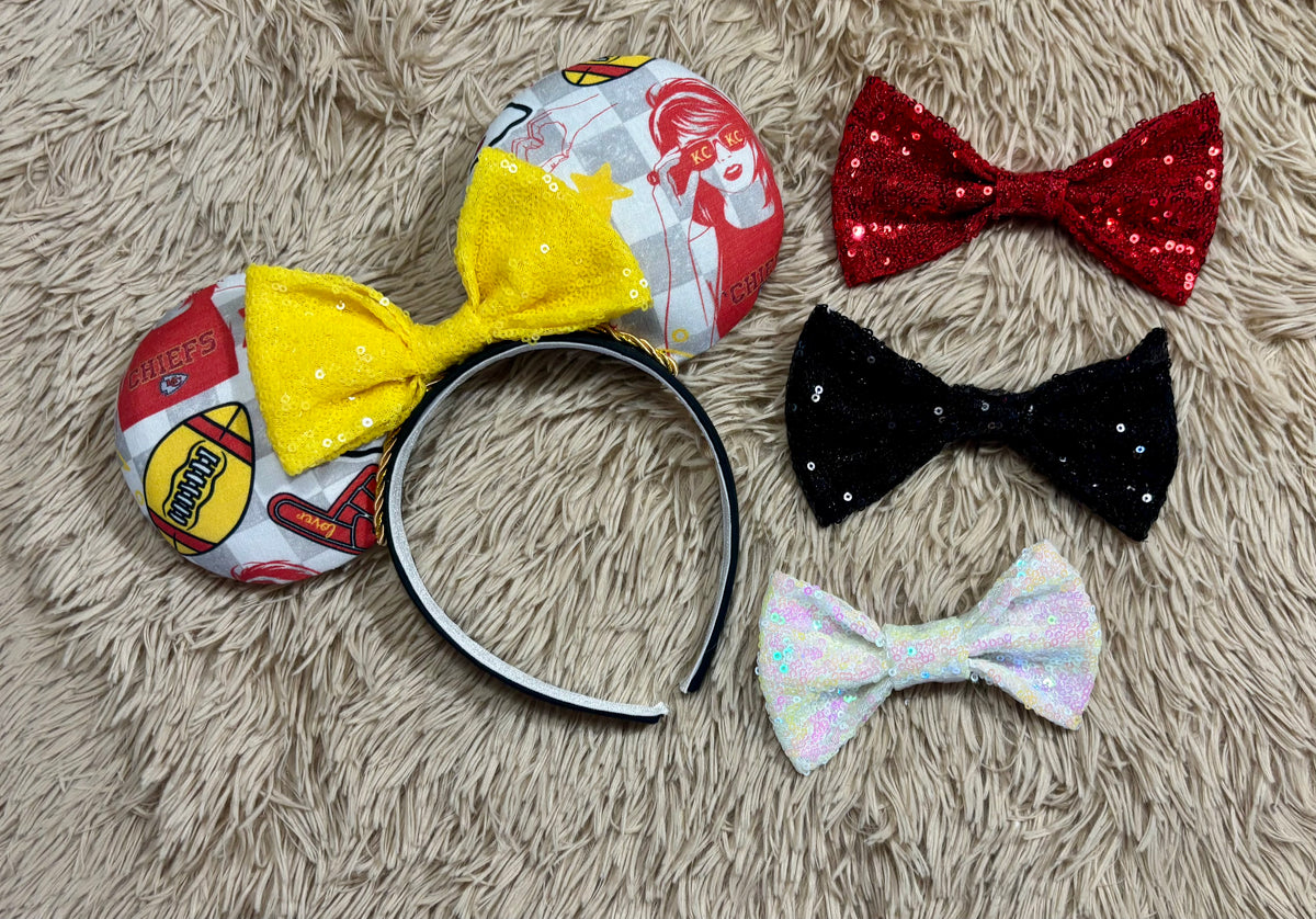 An ear headband featuring a bright yellow sequined bow. The set has TS and Chiefs images on it. Set on a universal sized headband. Shown with various bow options in case you don't want the default yellow bow/ Just write us a note in your order and we will attach the bow you prefer.
