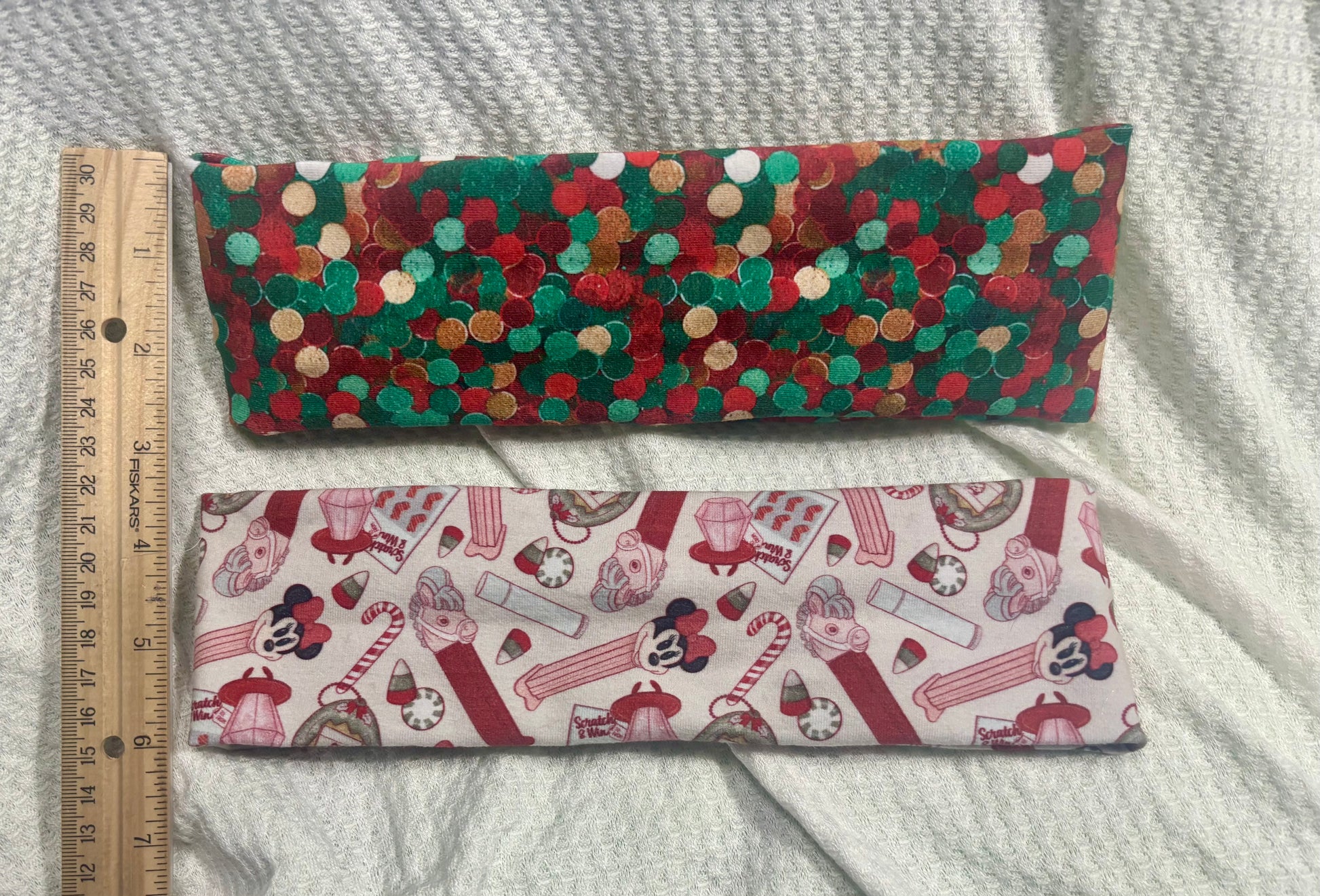 The back untwisted side of wraps. Two handmade and ready to ship twisted headbands. One in Christmas color dots and the other in Stocking Stuffers. Made with cotton Lycra fabric. 