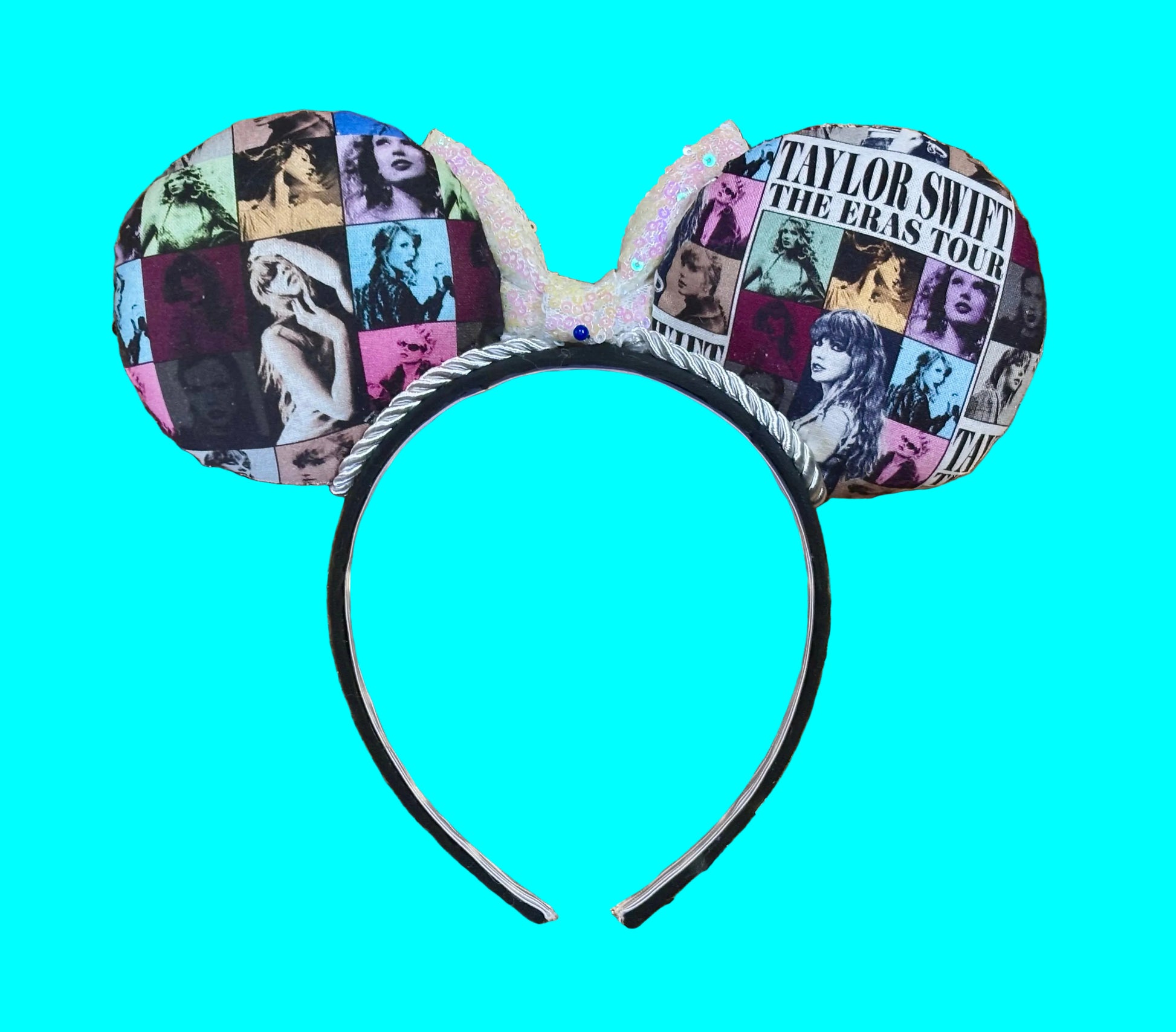 Back view of mouse ears. Eras Mashup Mouse Ear headband with white iridescent sequin bow. You can request any color sequin bow in your order by leaving a note. Handmade and ready to ship with fabric on both the front and the back of mouse ears. The set has a silver twisted trim along the inner ears. Ears are on a black poly cotton universal sized headband.