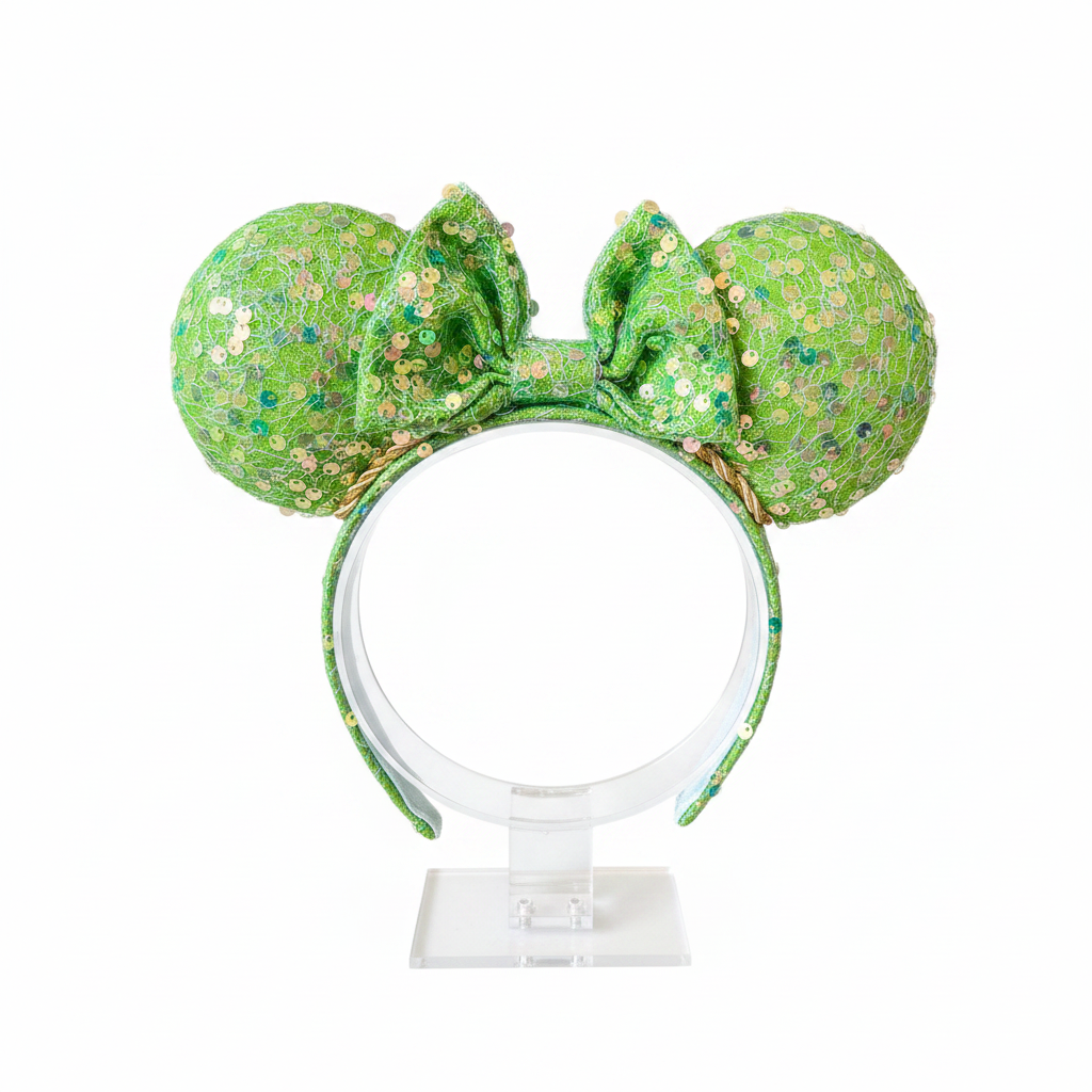 Bright lime Green sequin mouse ears on ears, headband and the bow with a gold trim. Shown on a white background