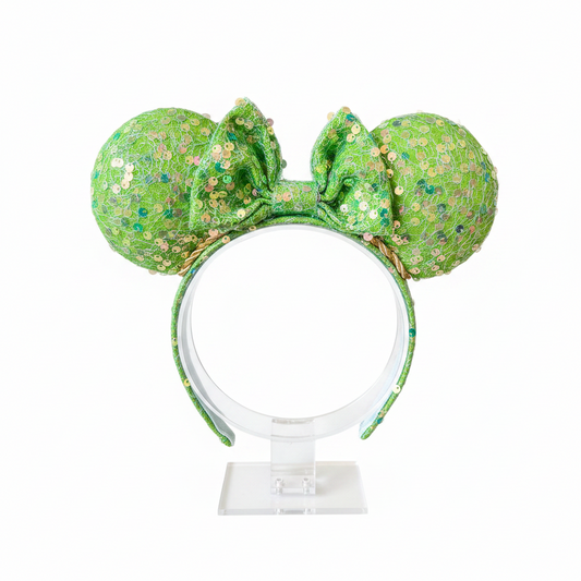 Bright lime Green sequin mouse ears on ears, headband and the bow with a gold trim. Shown on a white background