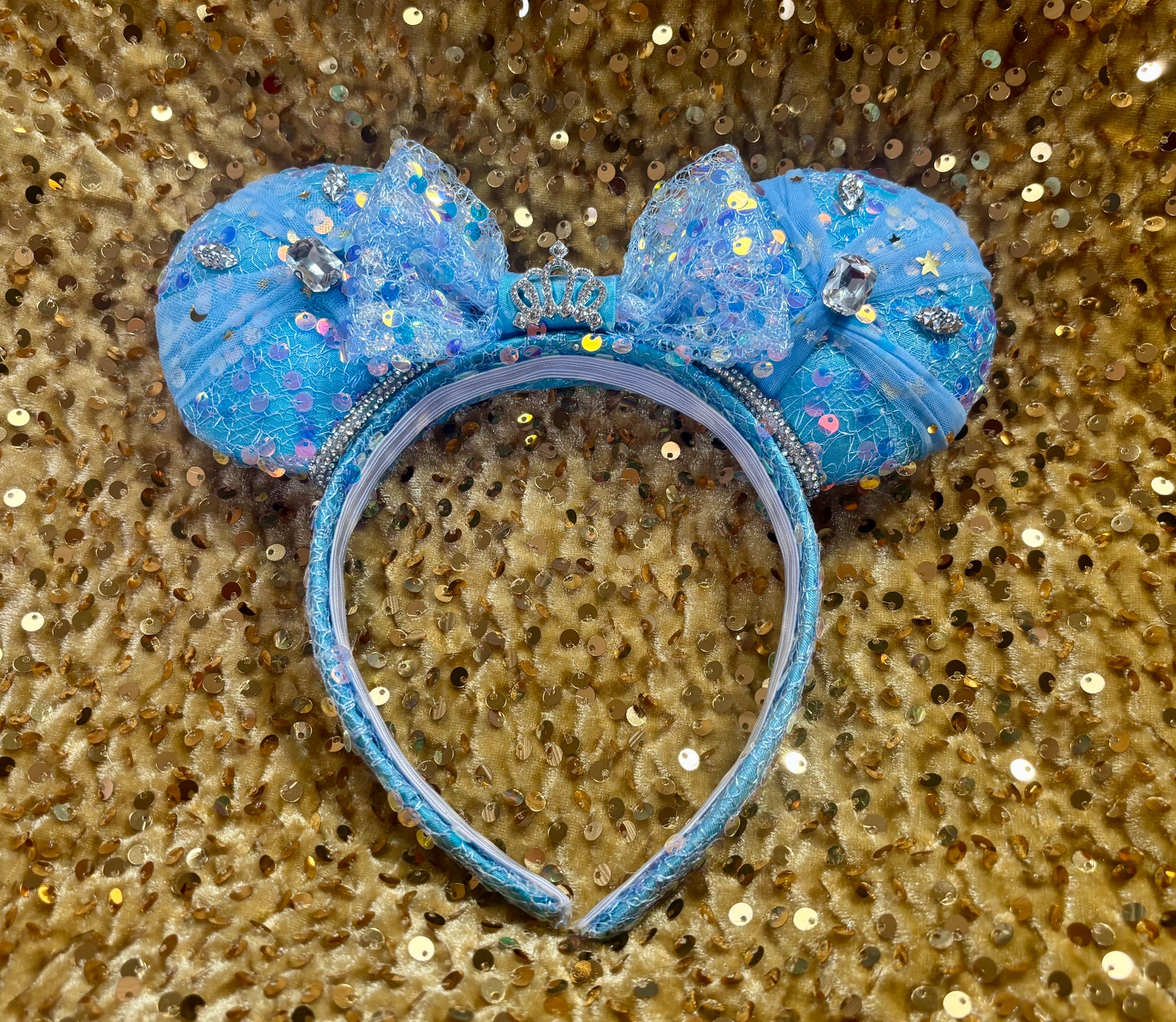 Blue glittery mouse ears headband on a gold sequin background. Handmade and ready to ship. 