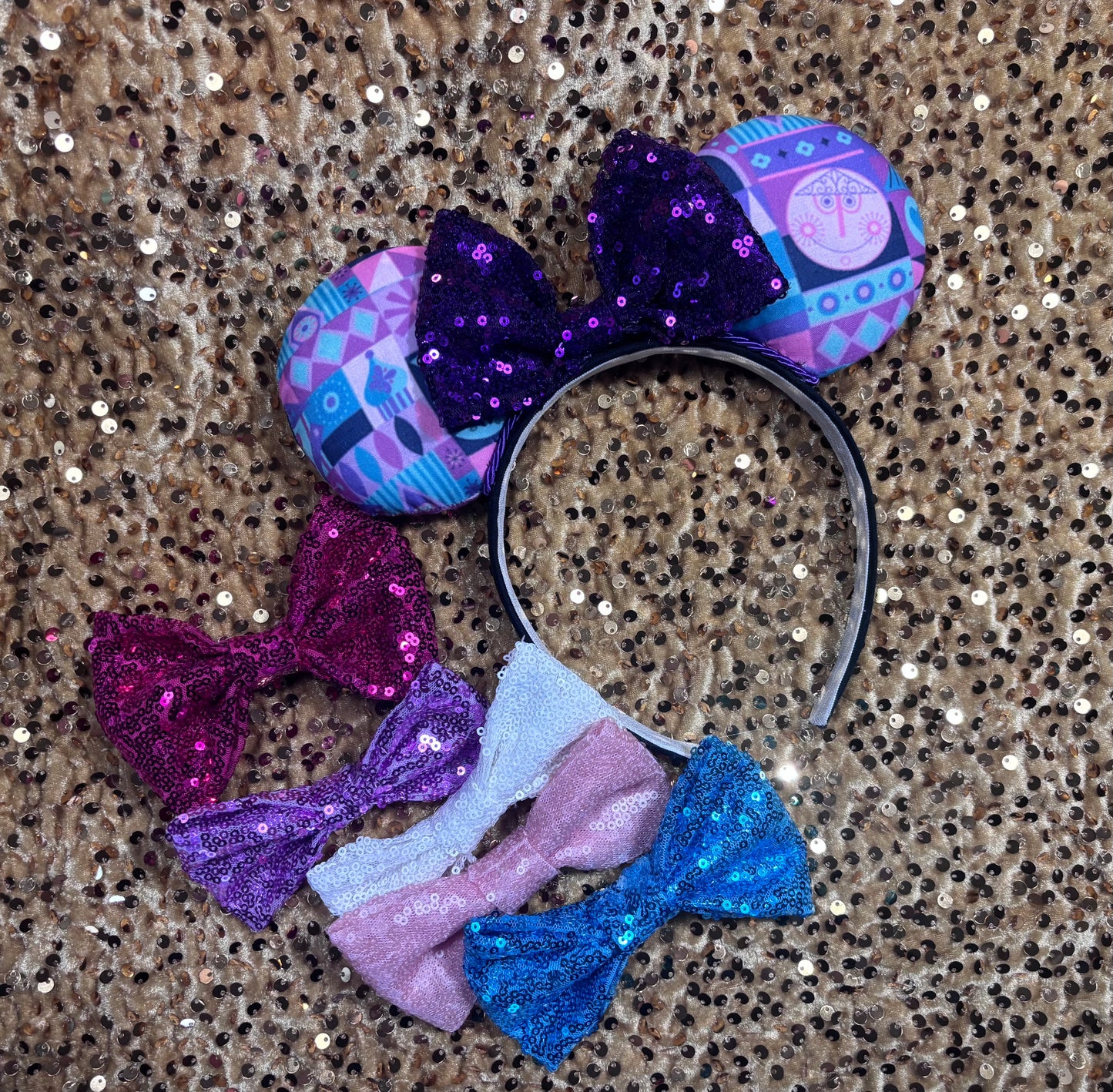 Colorful sequin bow headband with matching bows on a glittery background