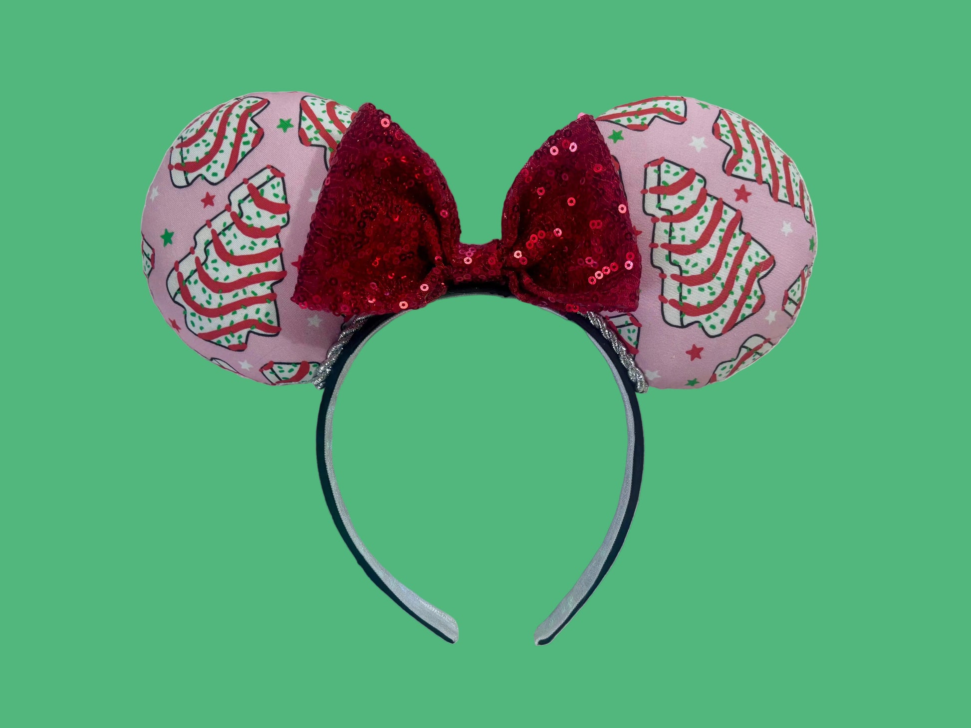 Handmade and ready to ship. Decorative headband with pink fabric and Christmas tree cake inspired fabric on the ears featuring a red sequin bow.