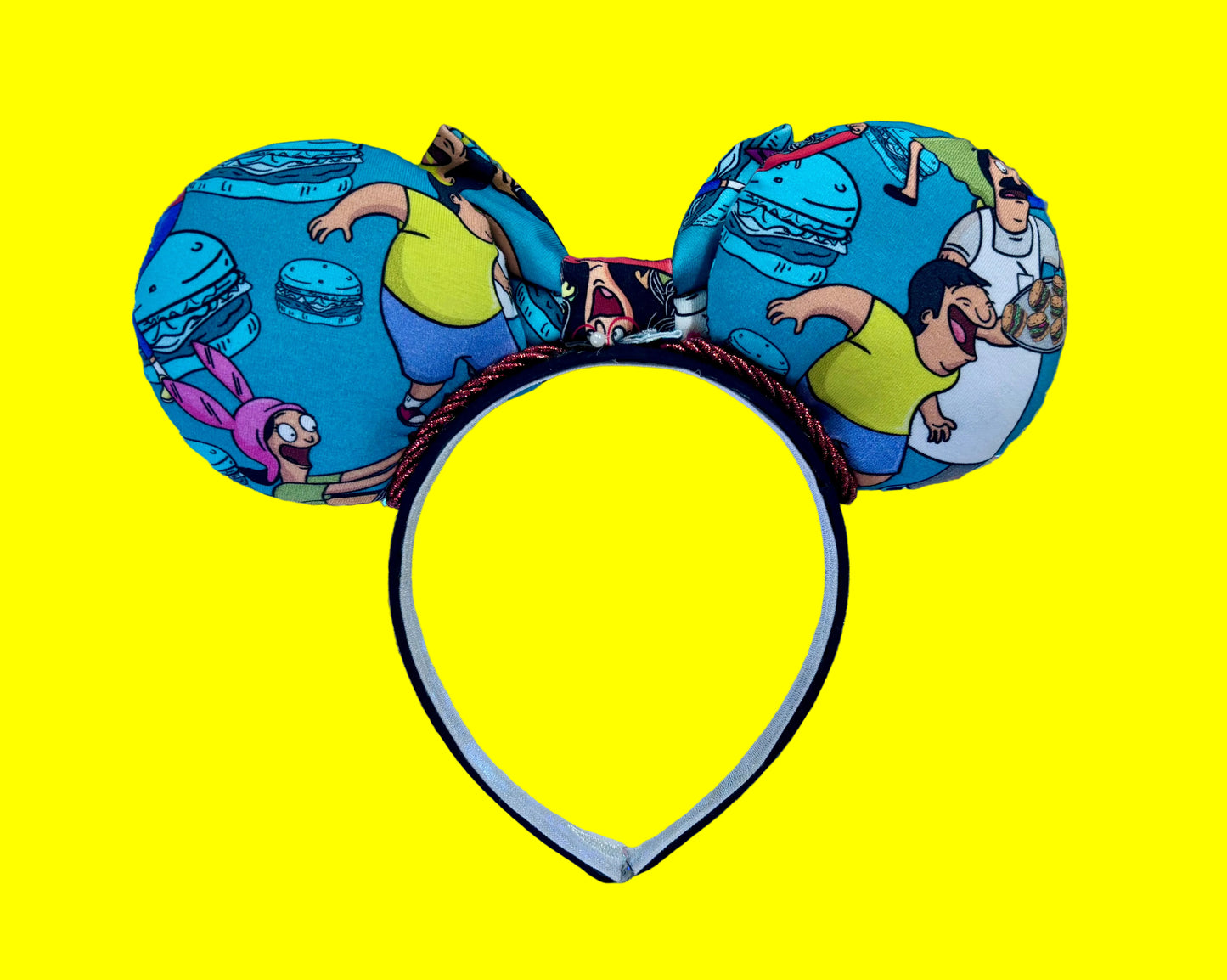 Back view of custom ears and red twisted trim. Handmade and ready to ship Burger Boss Mouse ears with the fabric on the ears, front and back and the bow. The headband is a universal sized headband and has black poly cotton fabric on it.