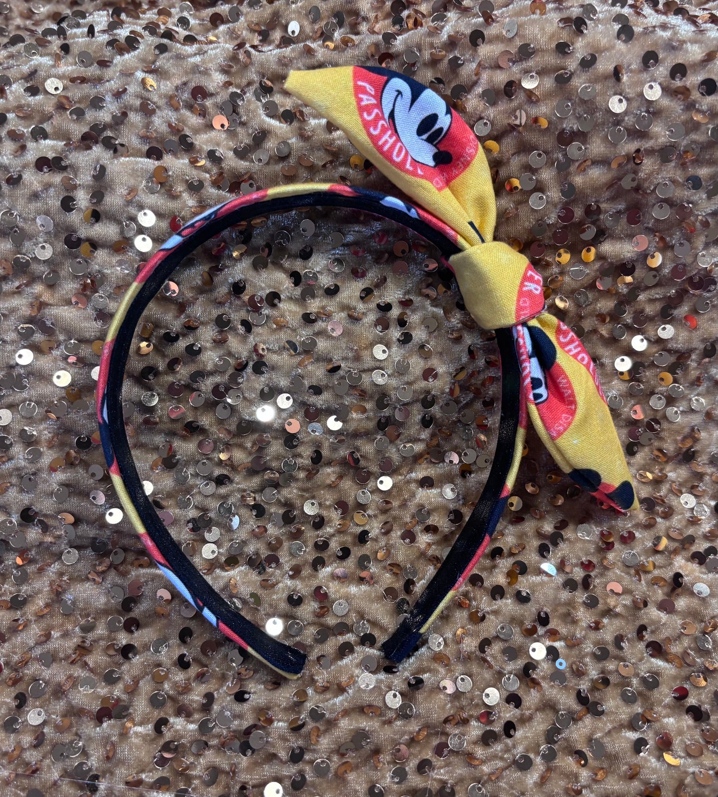 Headband with bow featuring a character design on a sequined background