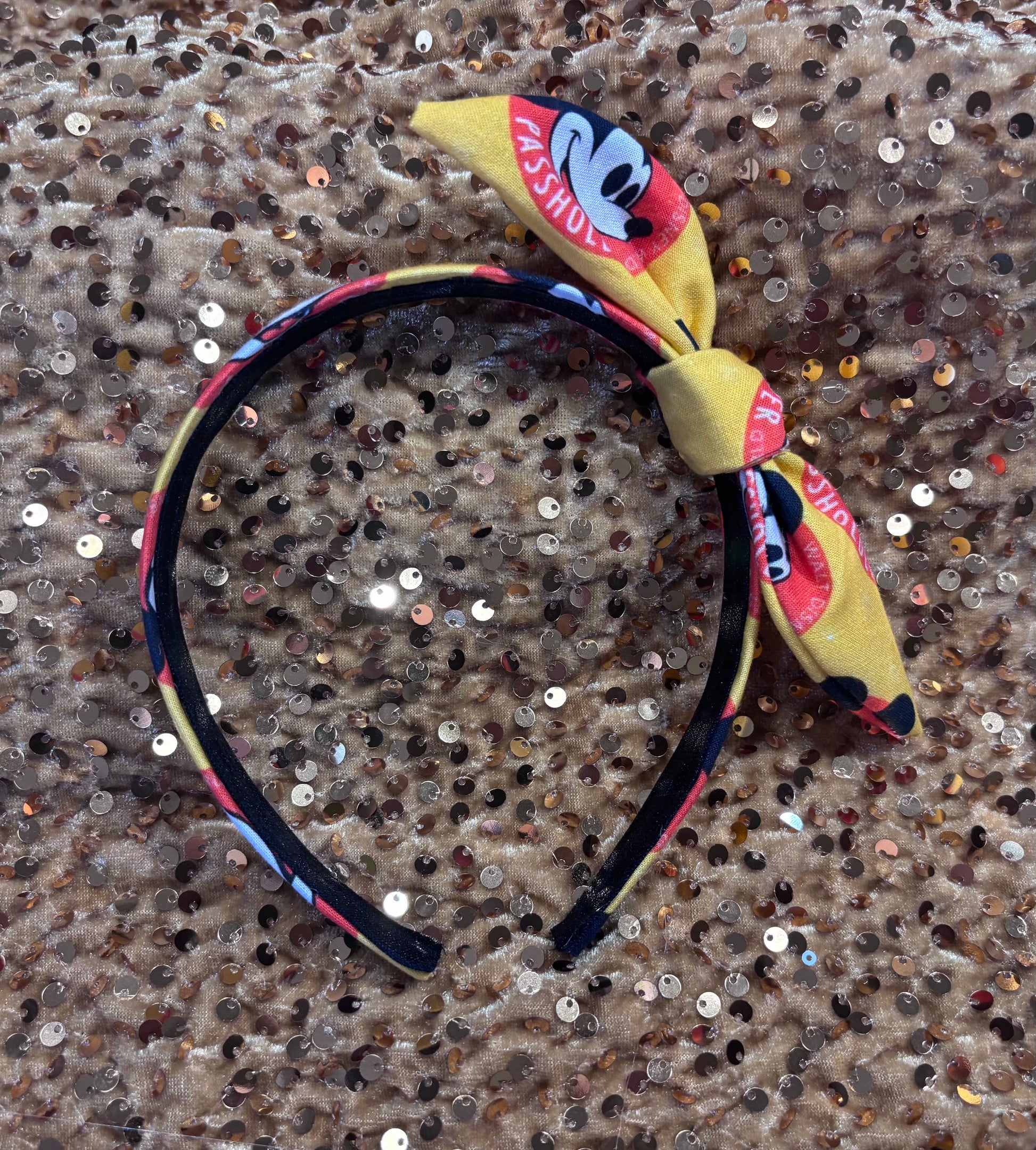 Headband with bow featuring a character design on a sequined background