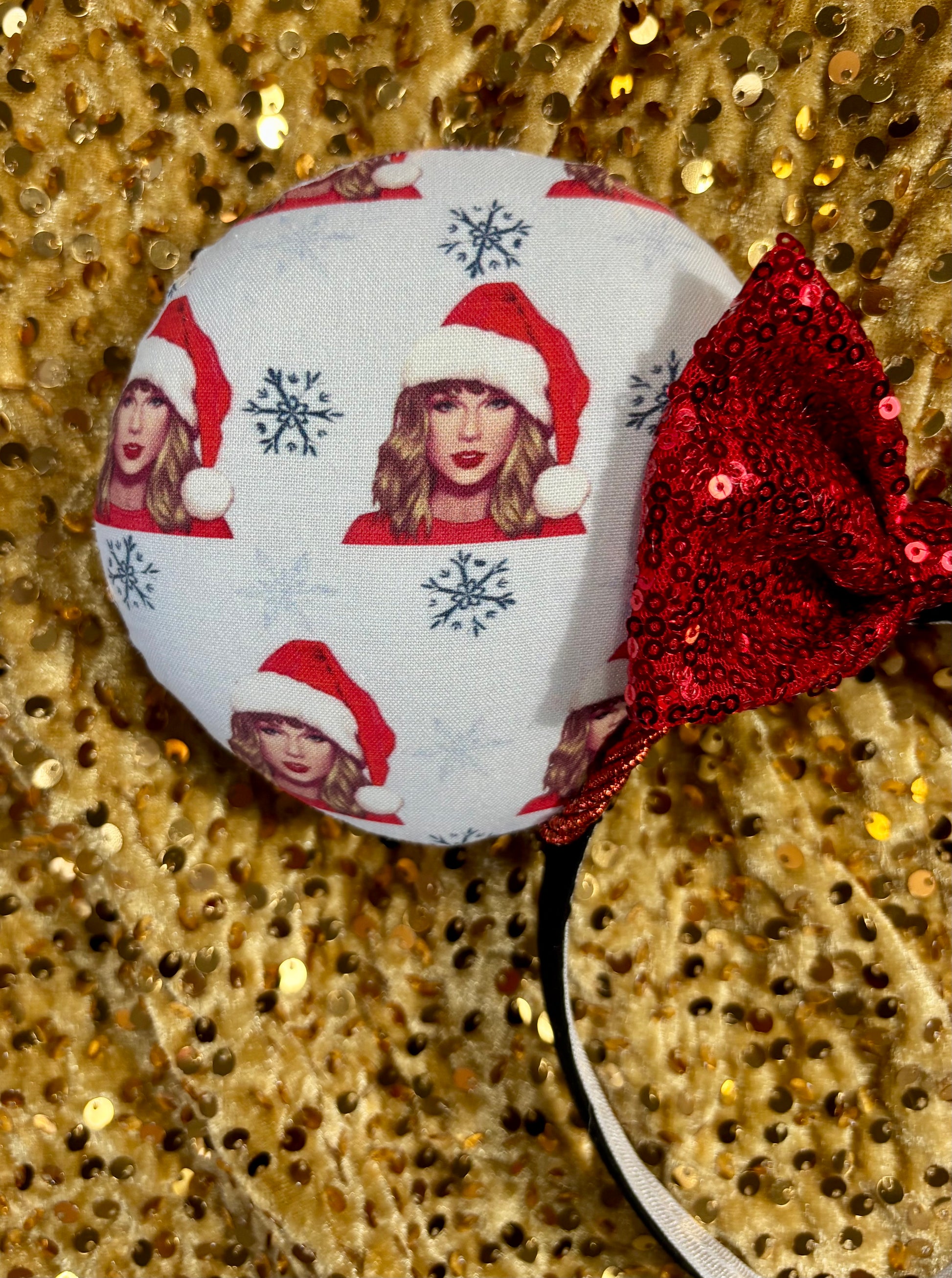 Mouse ear headband with red bow and character print on a glittery background